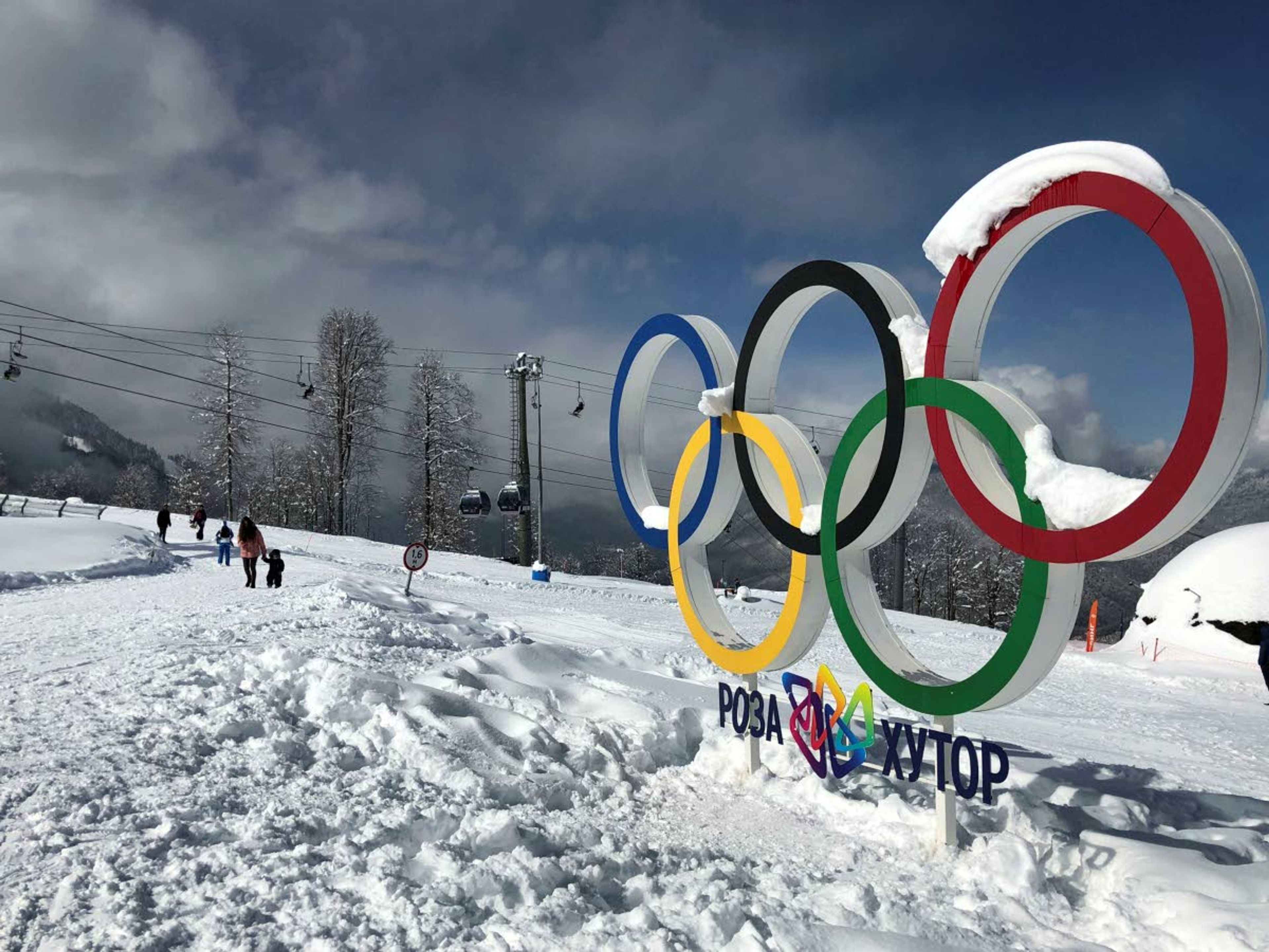 Tourists walk next to the Olympic rings at Krasnaya Polyana.