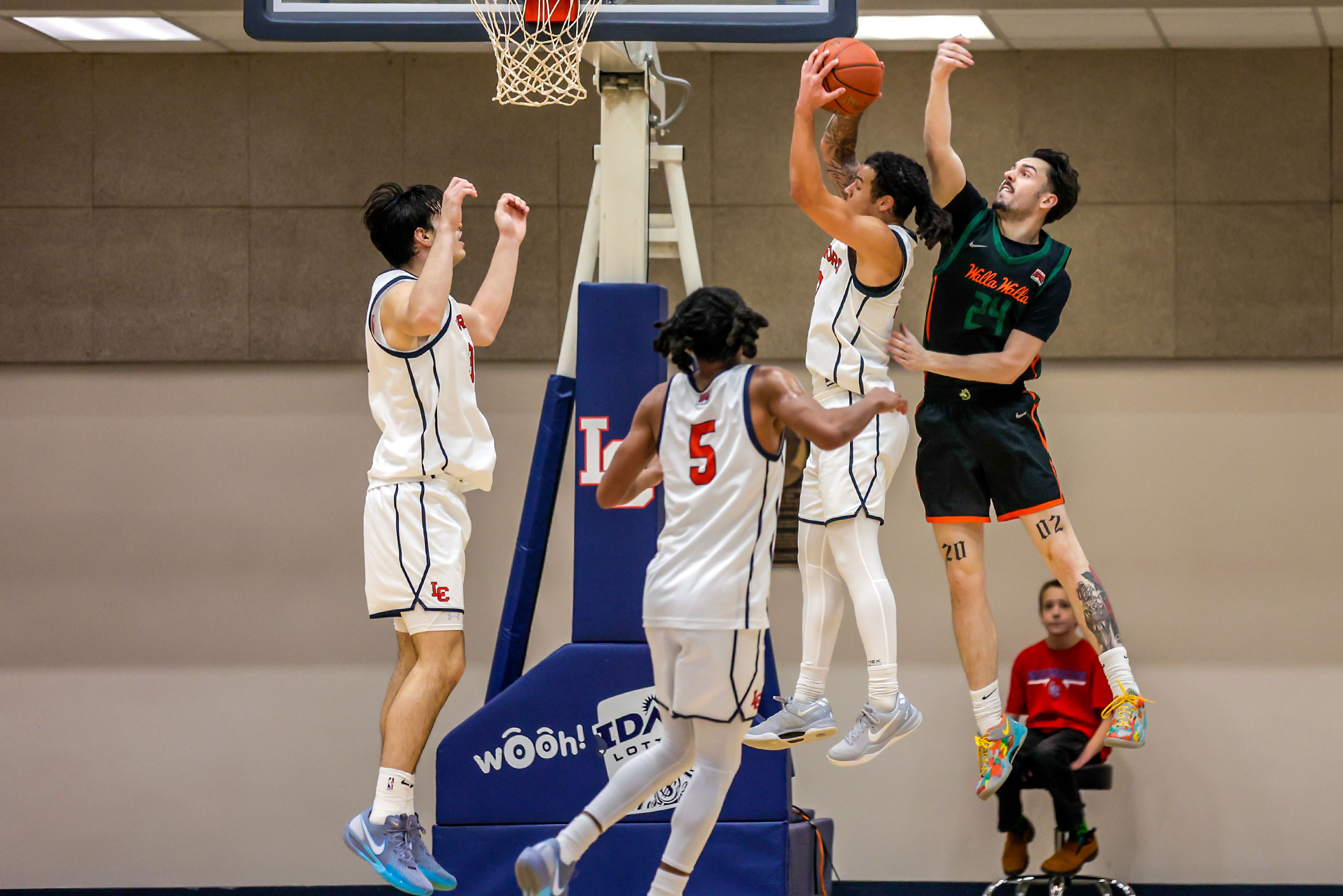 Lewis-Clark State guard MaCarhy Morris grabs the rebound over Walla Walla Forward Steele Twiford during a quarter of a Cascade Conference game Tuesday at Lewis-Clark State College in Lewiston.