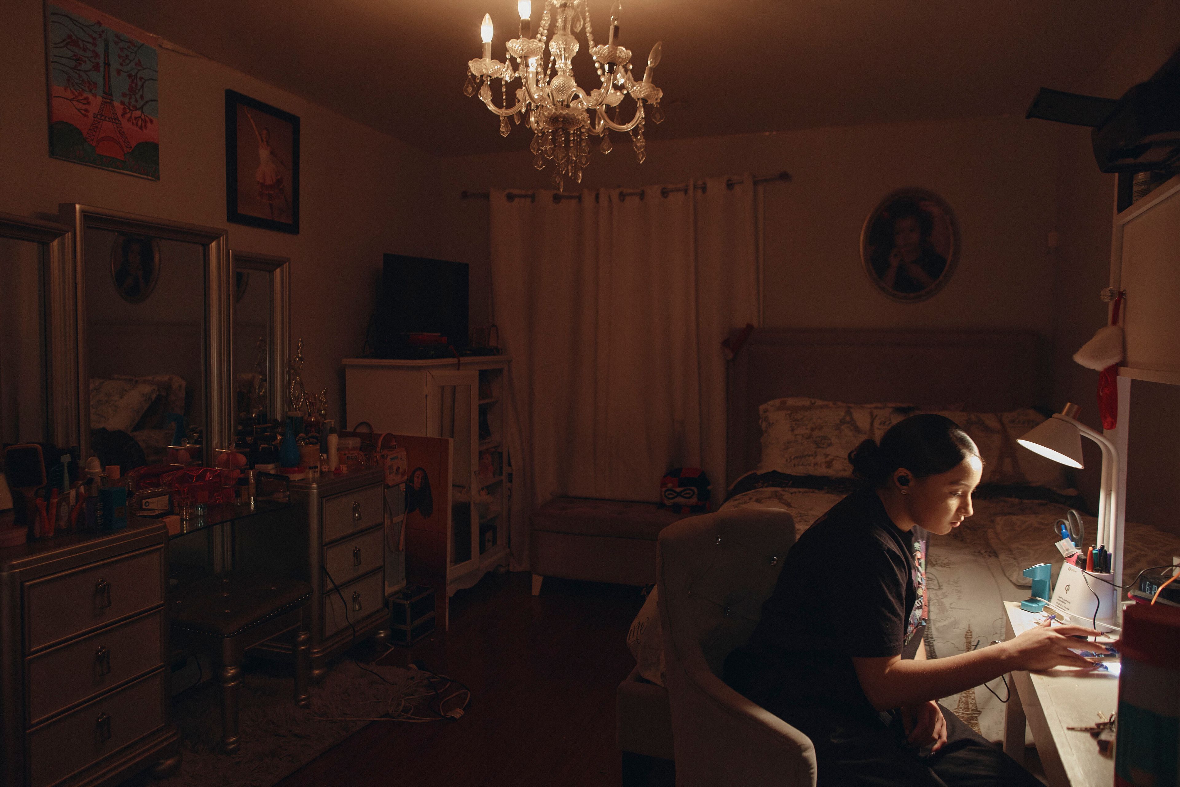 Gabriela Durham, 17, uses her phone to listen to music inside her room on Saturday, Jan. 27, 2024, in New York. With the damaging consequences of social media increasingly well documented, many parents are trying to raise their children with restrictions or blanket bans. Teenagers themselves are aware that too much social media is bad for them, and some are initiating social media “cleanses” because of the toll it takes on mental health and grades.