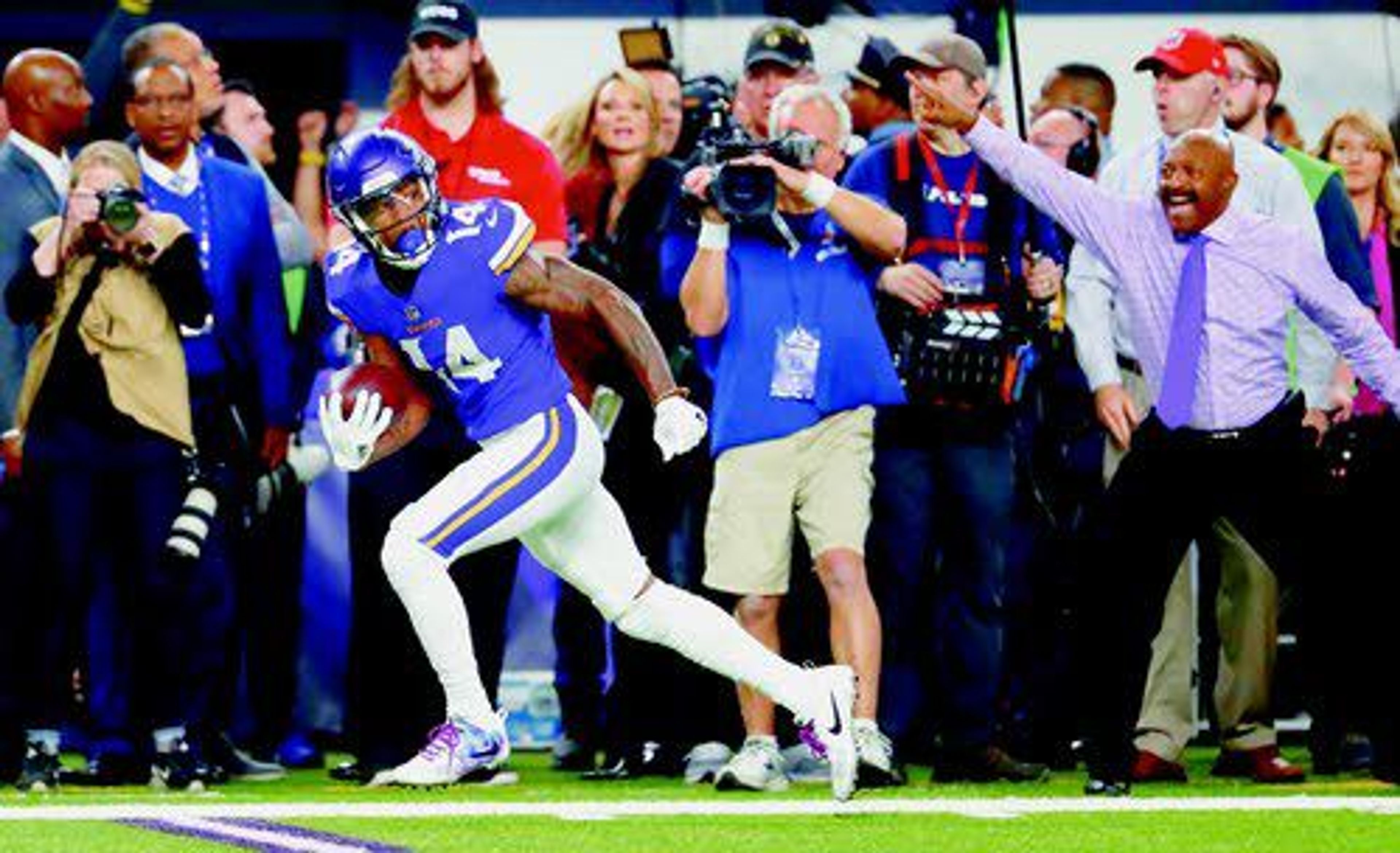 Digging it: Stefon Diggs escorts his prize to the end zone, giving the Vikings a 29-24 playoff Sunday win over the Saints.