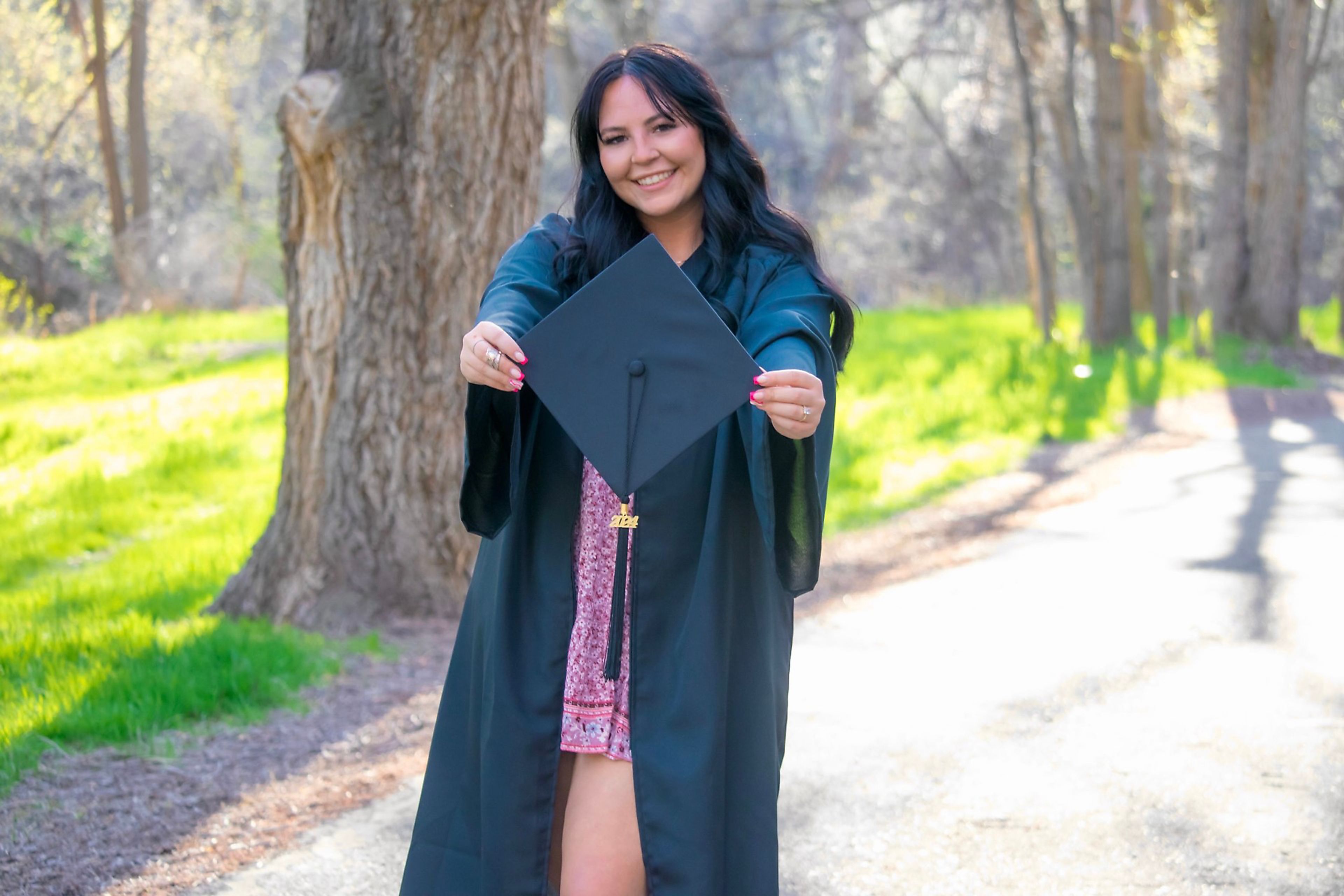 Tessa Guinn poses for a photo in graduation garb.