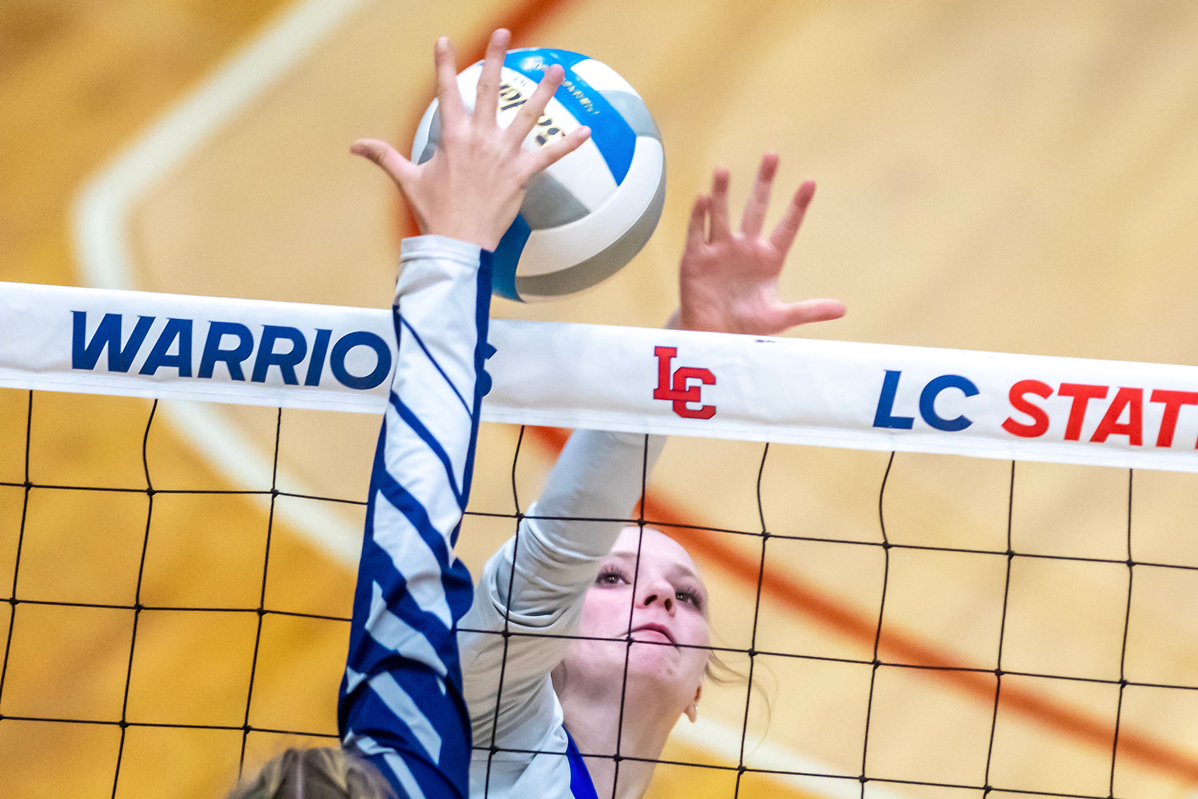 Genesee middle blocker Monica Seubert looks to get the ball over the net against St. John Bosco in a 1A district championship Thursday at the P1FCU Activity Center in Lewiston.,