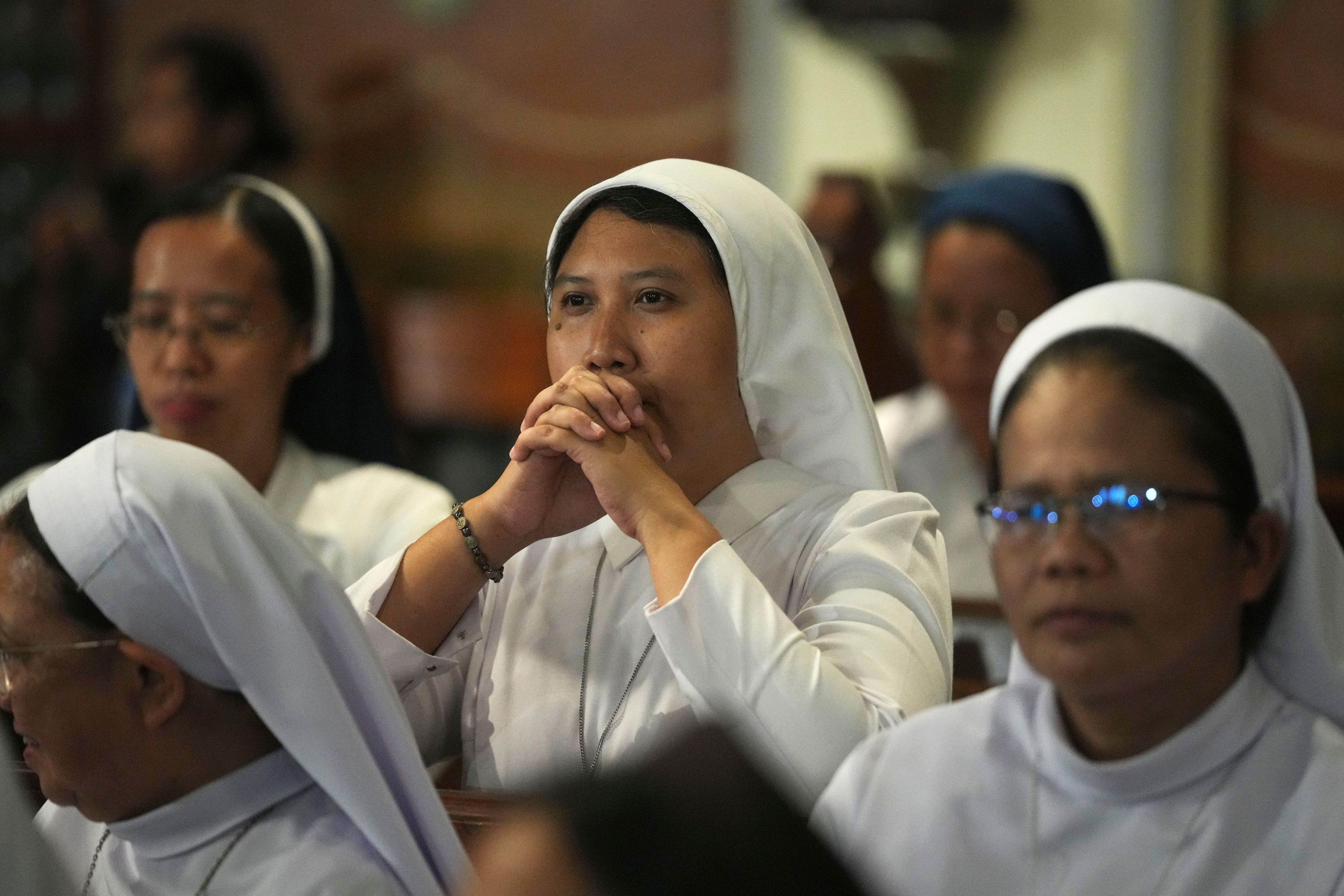 A nun prays ahead of the arrival of Pope Francis in the Cathedral of Our Lady of the Assumption, the capital's main Catholic cathedral, in Jakarta, Indonesia, Wednesday, Sept. 4, 2024.