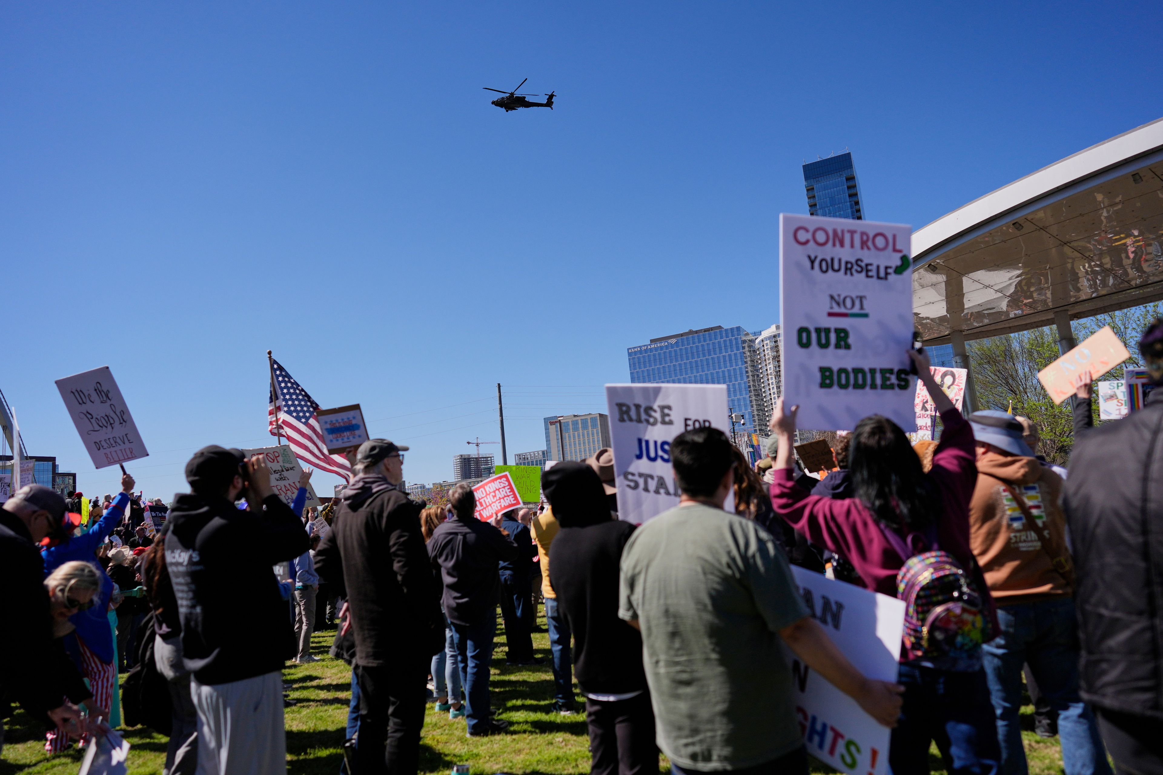 FILE - A military helicopter flies over a No Kings protest Saturday, March 28, 2026, in Nashville, Tenn. (AP Photo/George Walker IV, File)