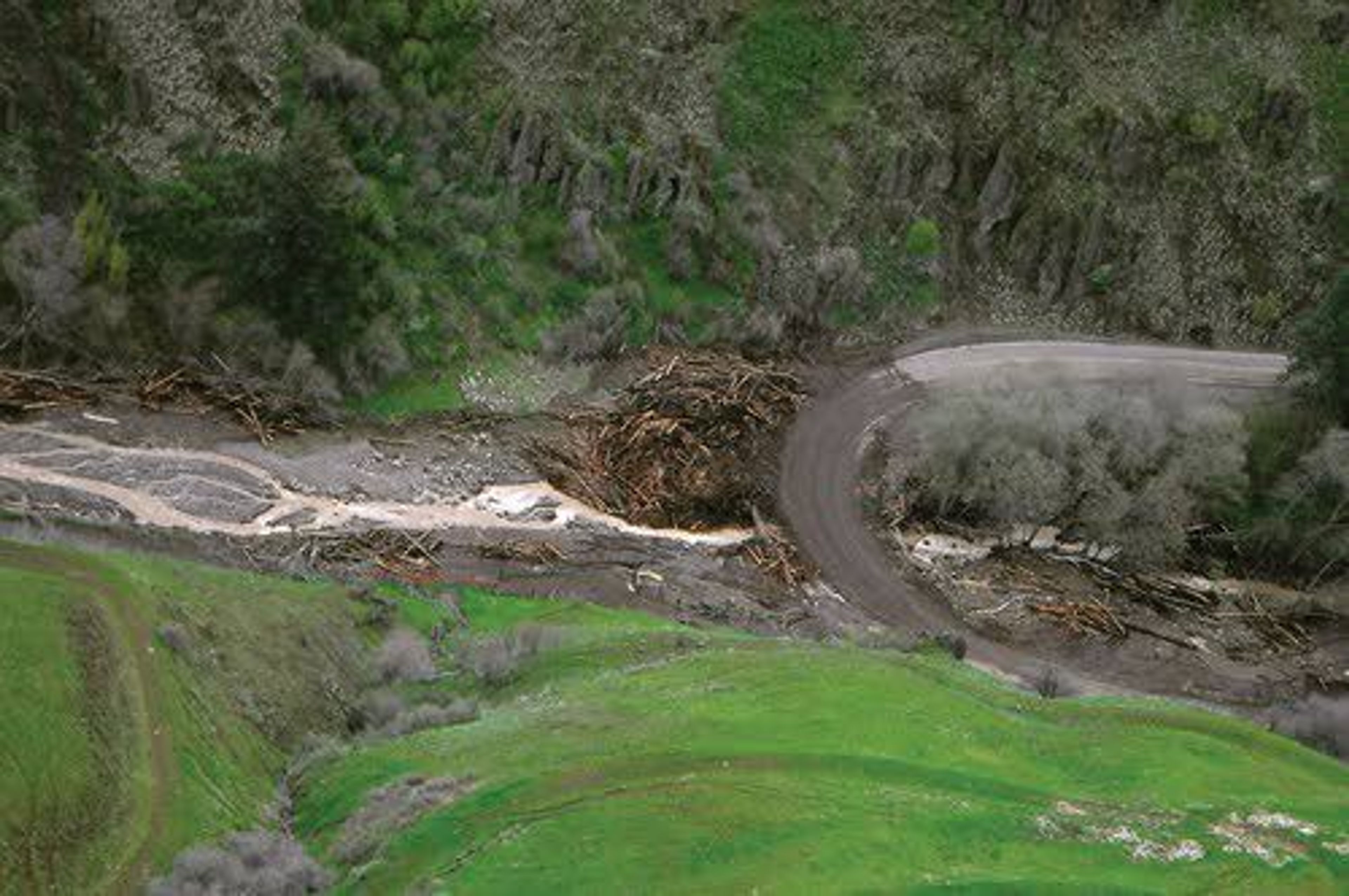 An aerial view shows the slide that happened last week on Rattlesnake Creek along State Route 129. Officials believe a man-made pond on private property likely caused the slide.