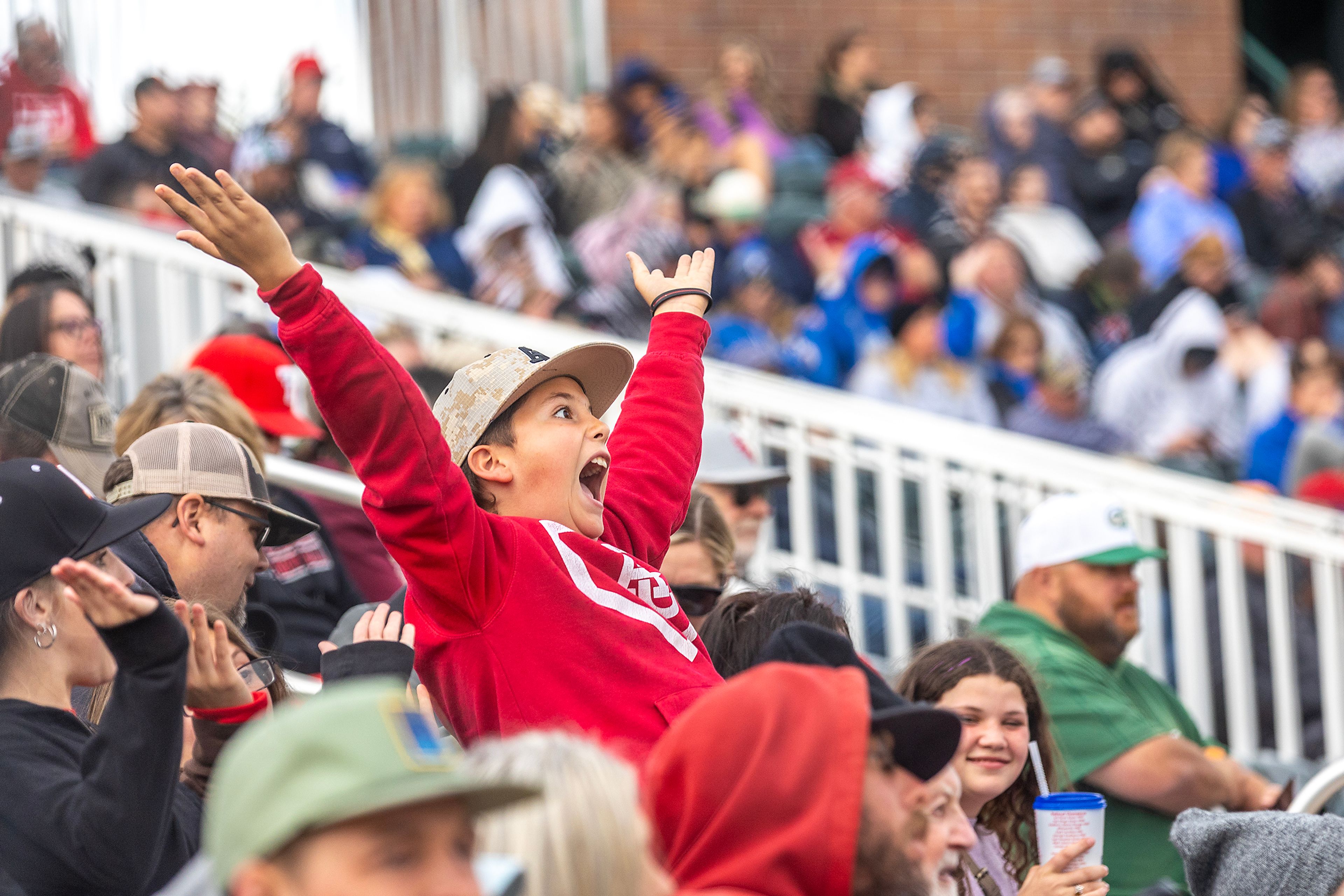 KJ McDonald, 11, the son of Arizona Christian Head Coach Joe McDonald, does the YMCA dance during their game against Southeastern in Game 7 of the NAIA World Series Saturday, May 25, at Harris Field in Lewiston.