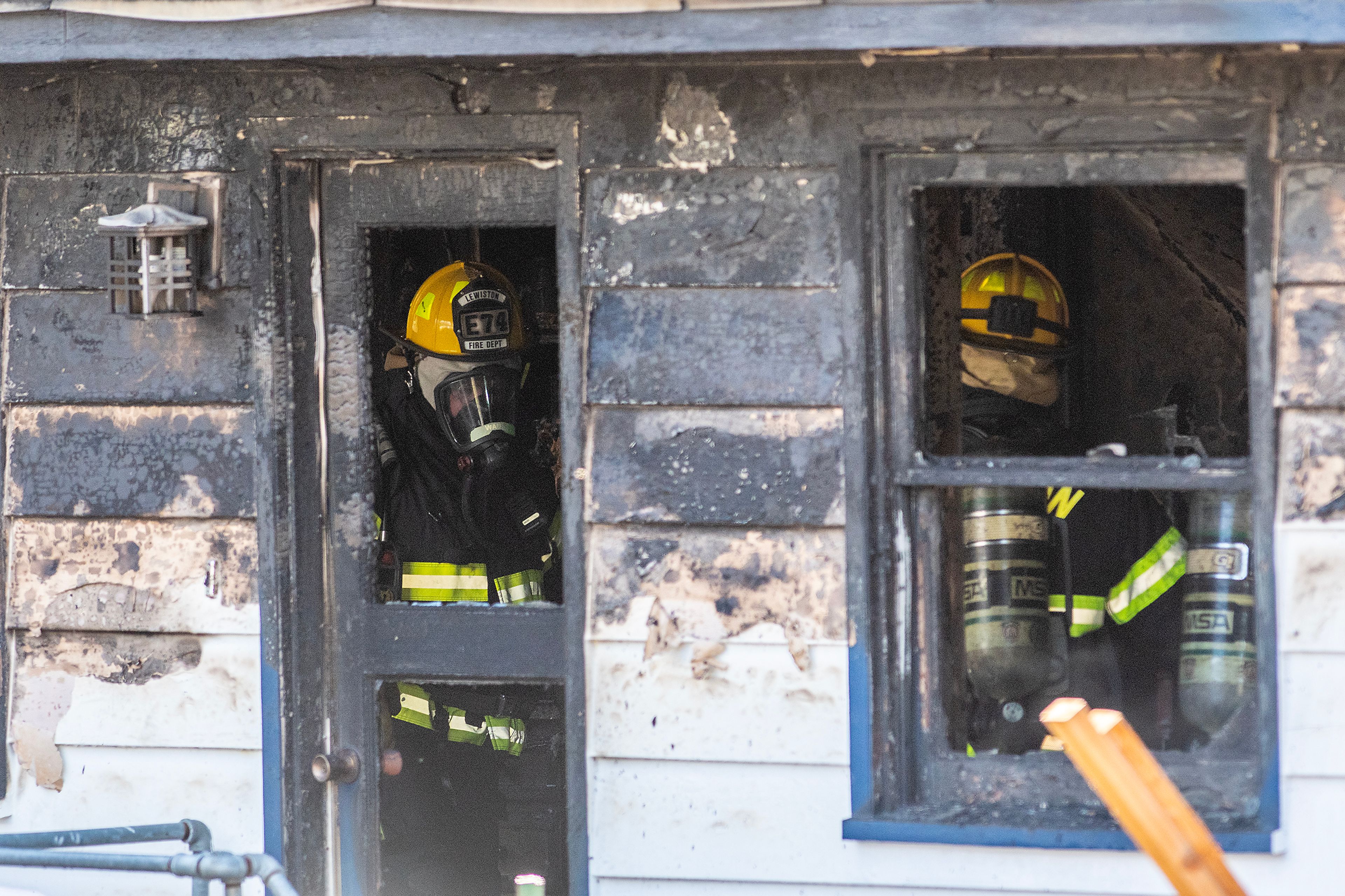 Lewiston Firefighters walks through a house at the scene of a structure fire Monday on the 1900 block of 13th Avenue in Lewiston.