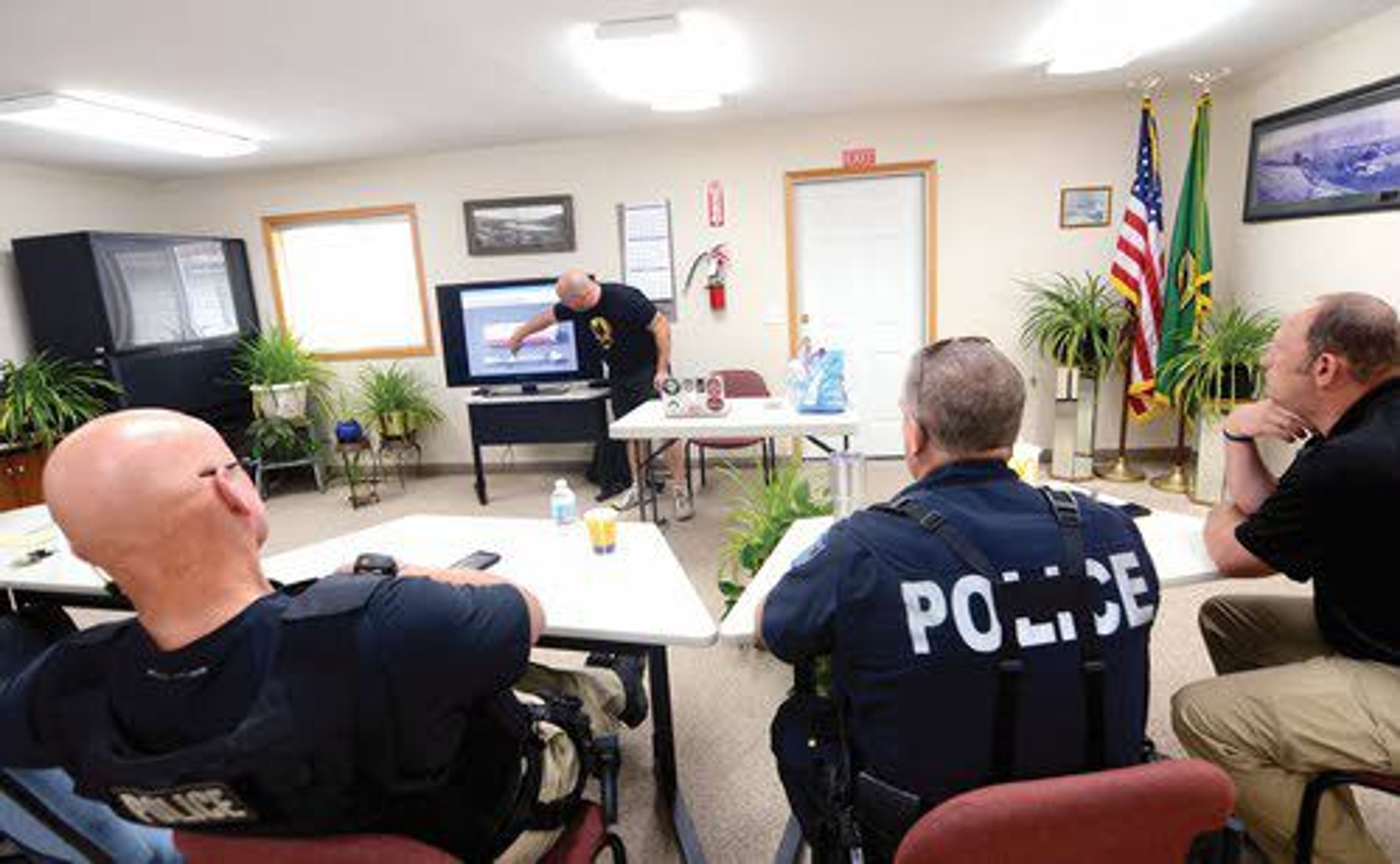 Jerid Hilderbrand, a paramedic with the Pullman Fire Department, presents information on Narcan — a drug used to treat opiate overdoses — to law enforcement officers during Asotin County’s opiate response training Wednesday at Asotin City Hall.