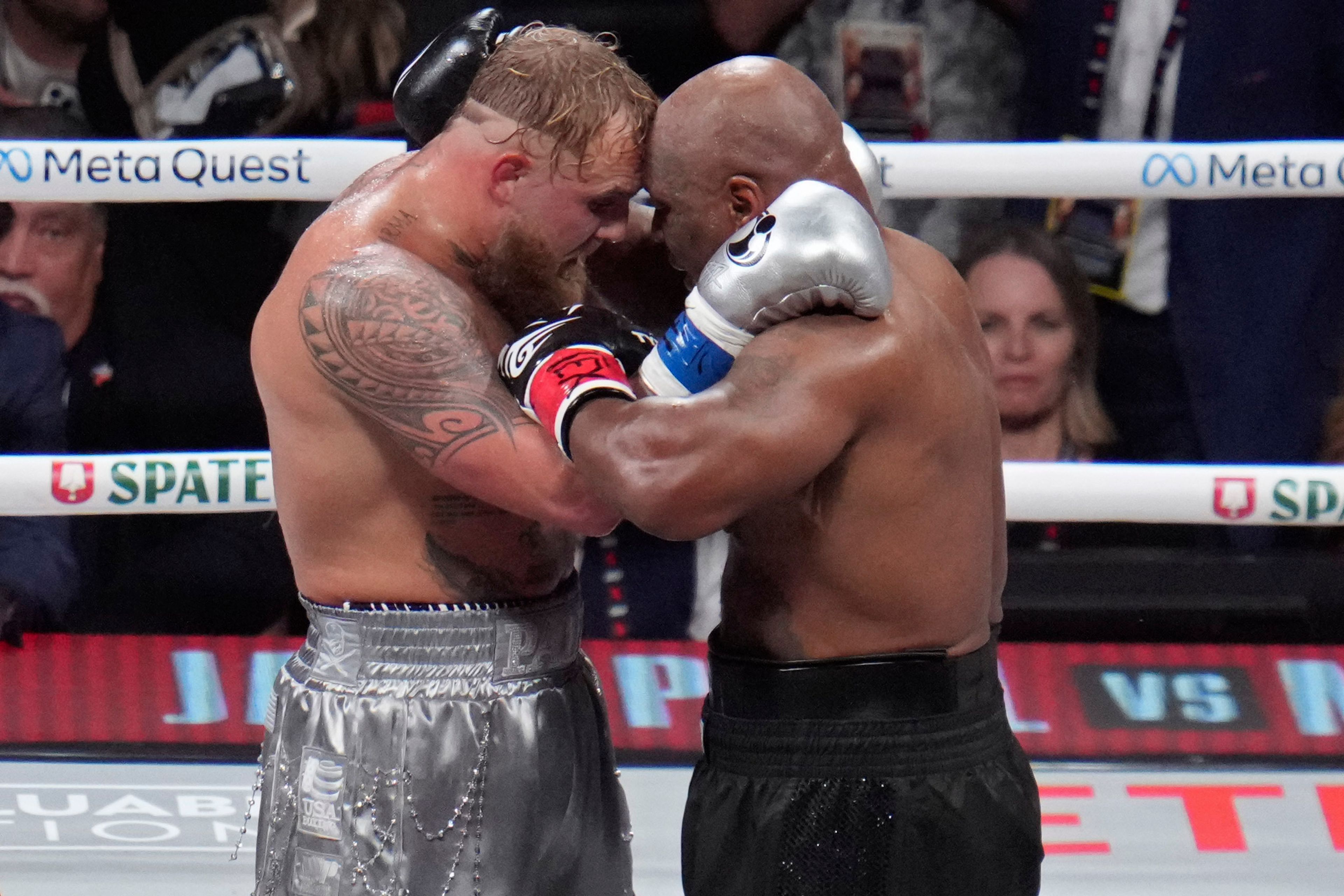 Jake Paul and Mike Tyson embrace after their heavyweight boxing match, Friday, Nov. 15, 2024, in Arlington, Texas. (AP Photo/Julio Cortez)