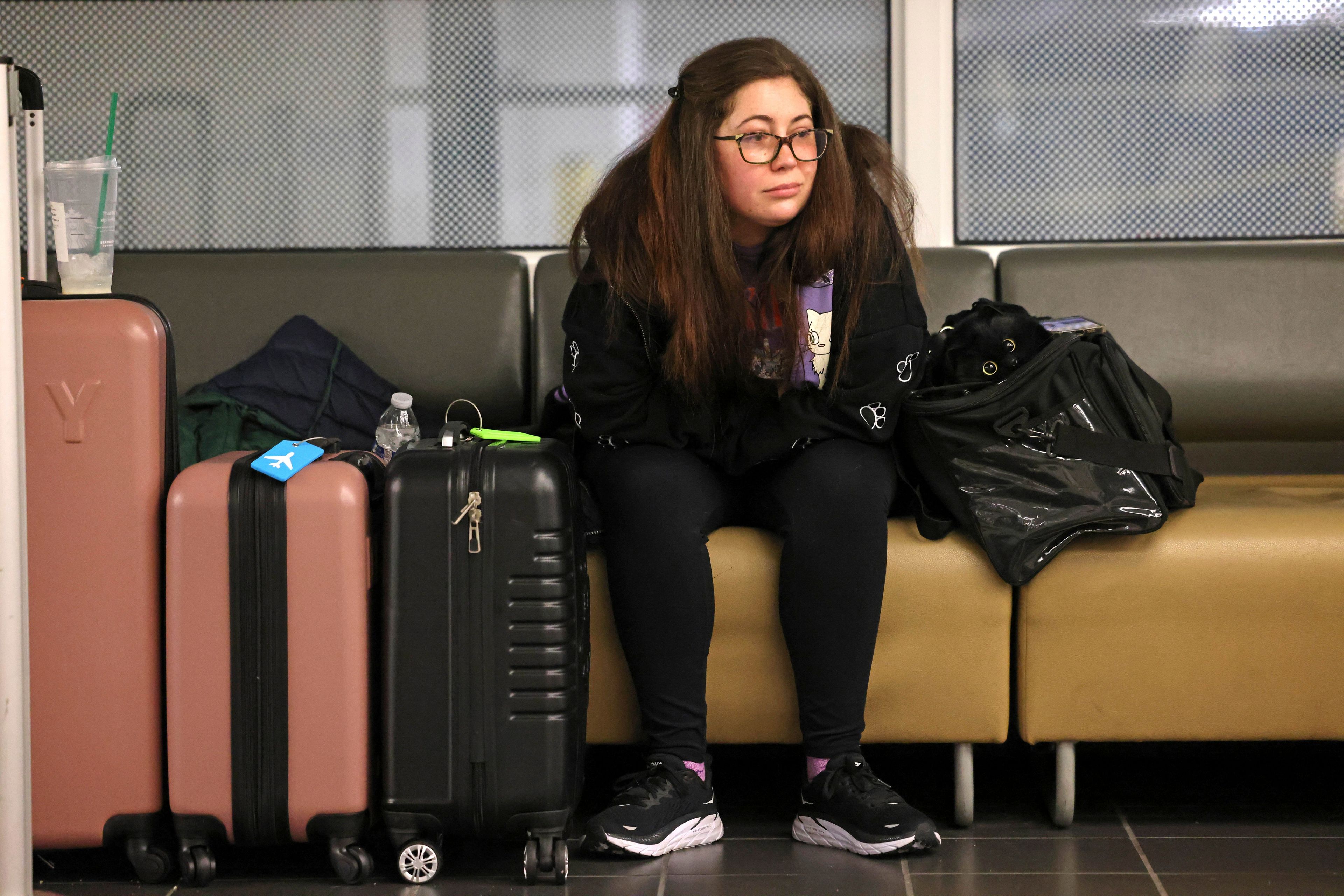 Stephanie Shinn from Kenmore waits three hours at this point while her husband waits in line to rebook their flight to Philadelphia after their flight on Alaska Airlines was canceled at Seattle-Tacoma International Airport on Saturday, Jan. 6, 2024, in SeaTac, Wash. Alaska Airlines canceled more than 100 flights after grounding Boeing's fleet of 65 Max 9s for inspections following Friday's emergency landing of a Boeing 737 Max 9 jetliner. (Karen Ducey/The Seattle Times via AP)