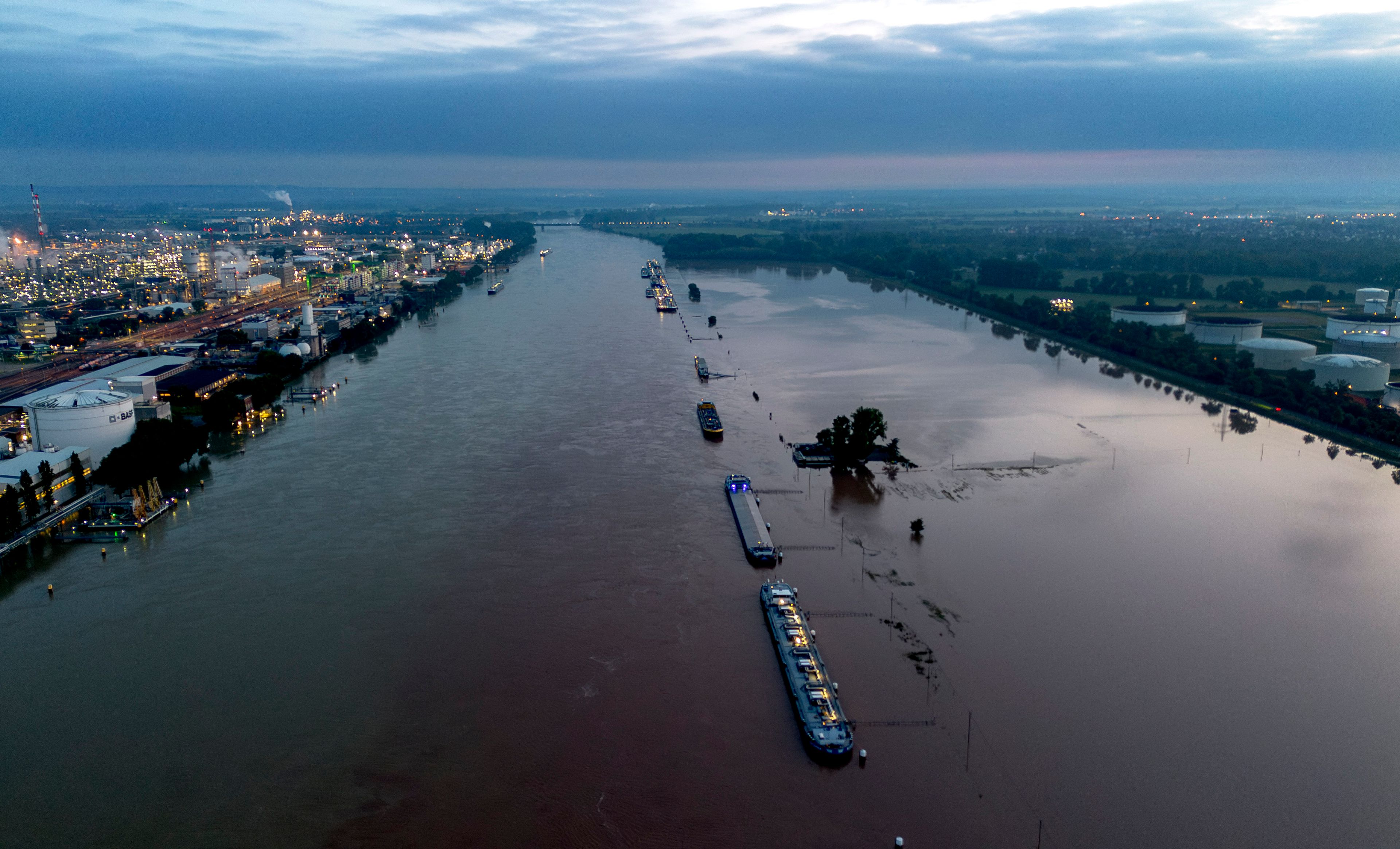 Cargo ships park at the bank of the river Rhine near the BASF chemical plant in Ludwigshafen, Germany, Tuesday, June 4, 2024. The Rhine left its banks after heavy rain falls in southern Germany during the last days.