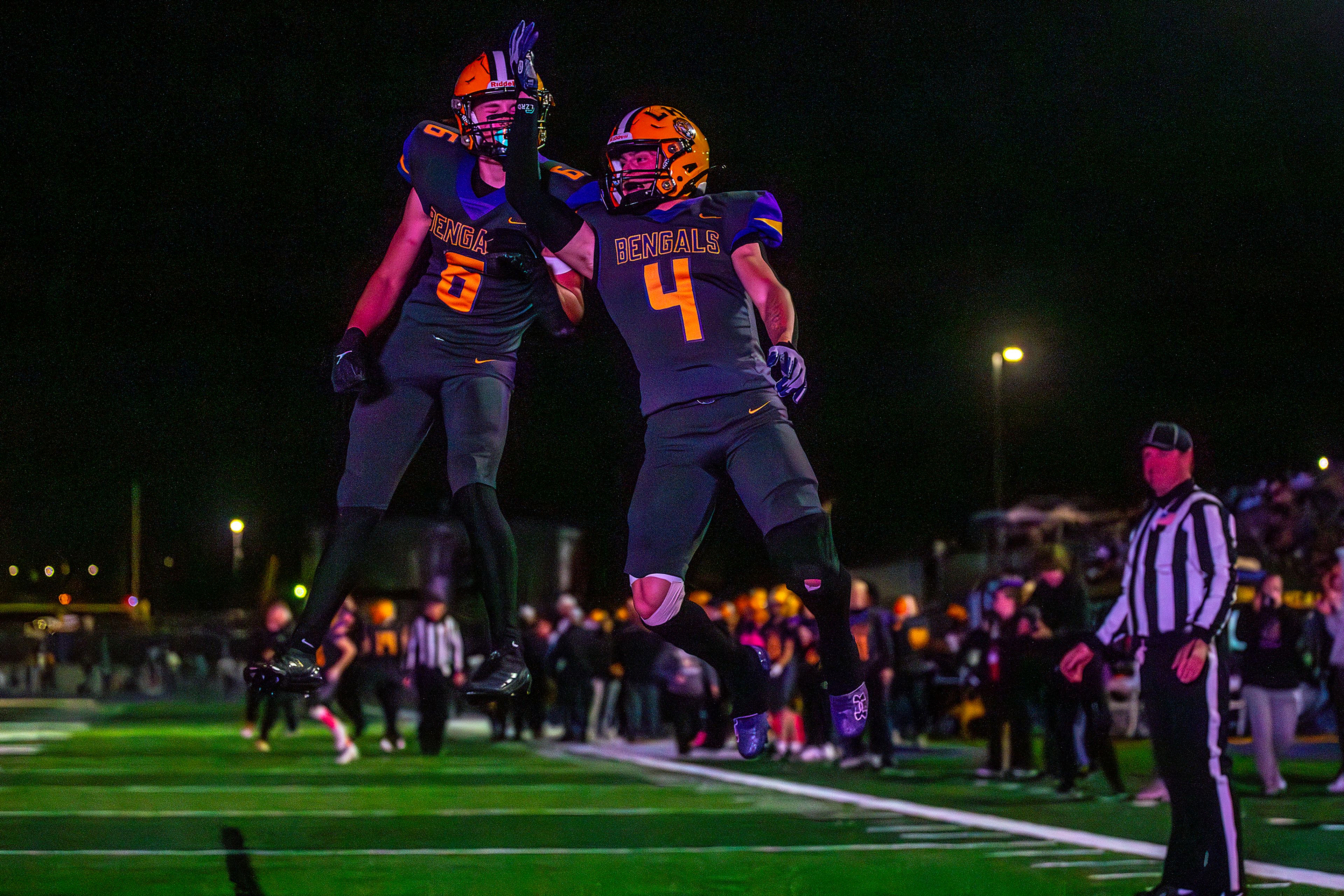 Lewiston running back Noah Carpenter (4) and Nathan King celebrate a touchdown against Lake City in a nonconference game Friday at Lewiston High School.,