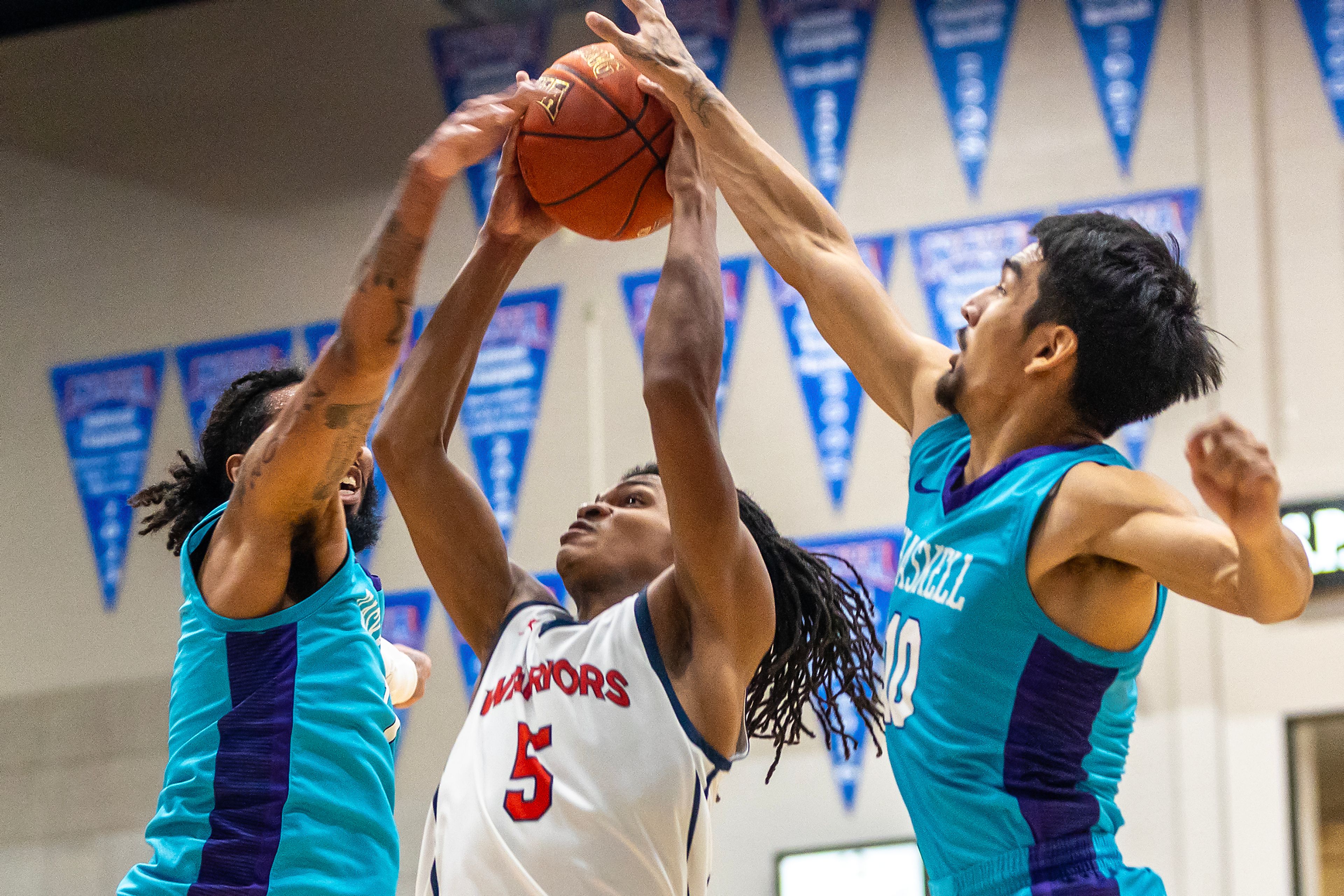 Lewis-Clark State guard Gordon Boykins looks to shoot the ball as Haskell�s DK Middleton and Taurice Grant guard the basket during the season opening game as part of Tribal Nations Weekend Saturday in Lewiston.,