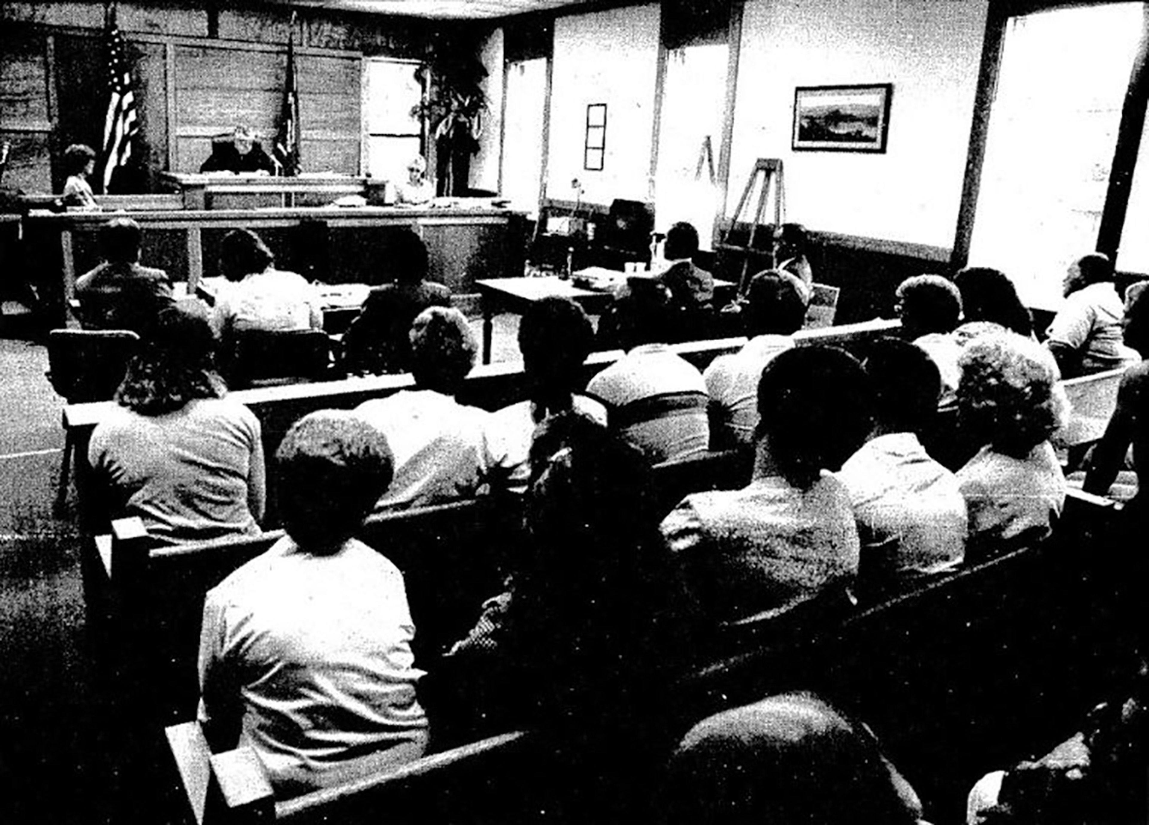 Superior Court Judge John M. Lyden presides over the Susan Kroll murder-for-hire trial before a packed courtroom of relatives and spectators at Asotin. In this photograph taken Aug. 17, 1989, Kroll is seated at the counsel table on the left, between her attorney and her private investigator. At the table to the right are Prosecutor Timothy J. Ohms, seated on the left, and Detective Mike Barr of the Washington State Patrol.