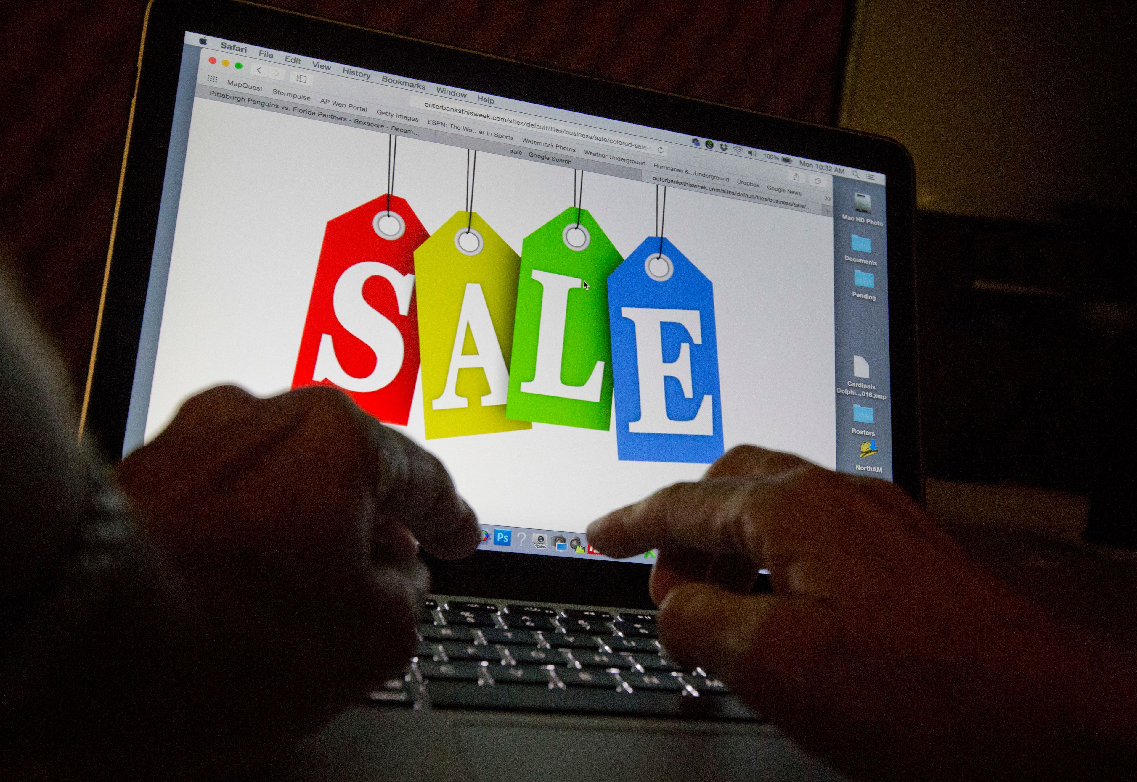 FILE - A person searches the internet for sales, on Dec. 12, 2016, in Miami. An internet trade group on Thursday, June 6, 2024, sued the state of Georgia to block a law requiring sites to gather data on high-volume sellers who advertise goods online and collect payment in cash or some other offline method.