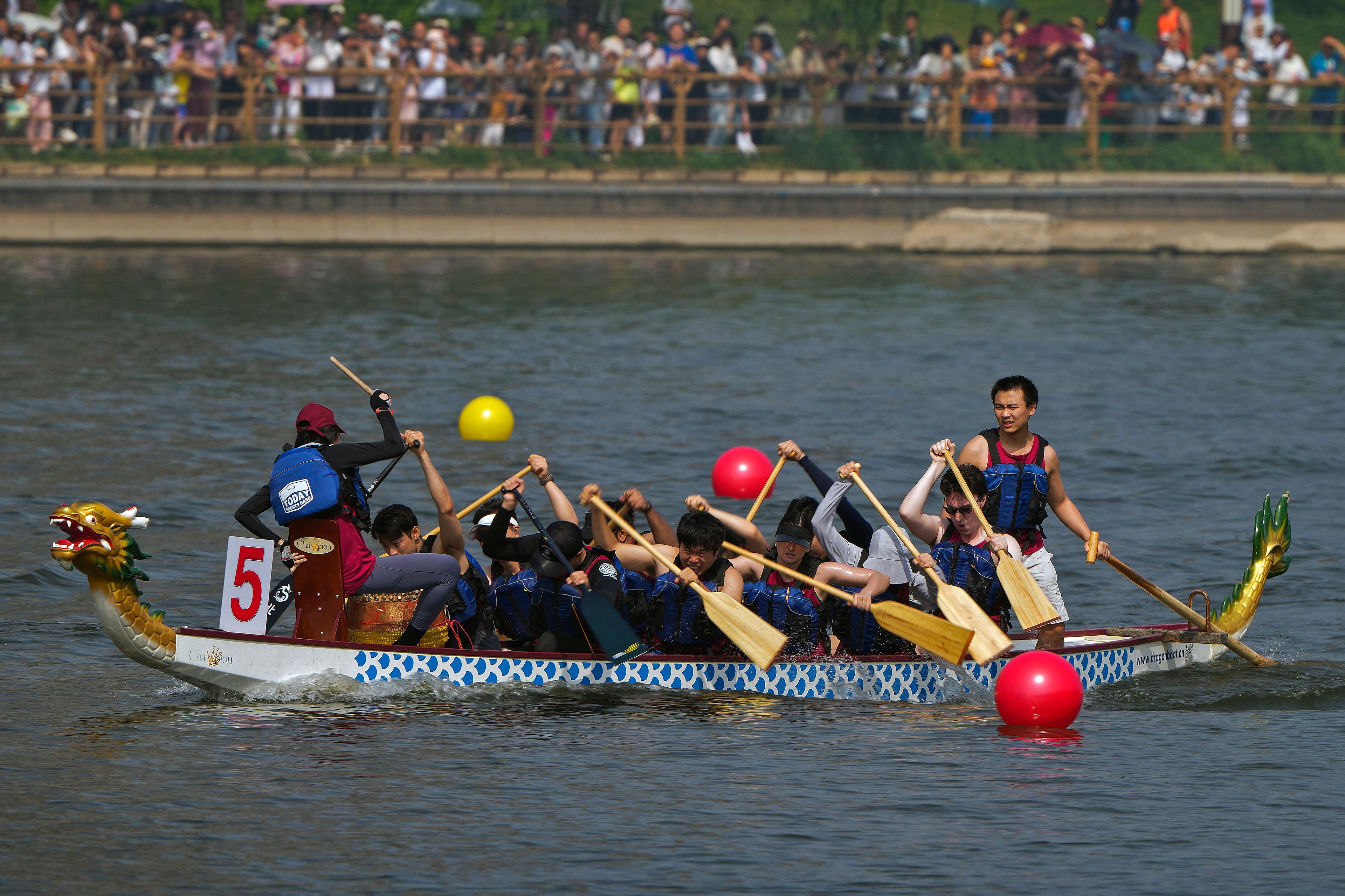 A team of dragon boat racers paddle their boat during the Dragon Boat Festival at a canal in Tongzhou, outskirts of Beijing, Monday, June 10, 2024. The Duanwu Festival, also known as the Dragon Boat Festival, falls on the fifth day of the fifth month of the Chinese lunar calendar and is marked by eating rice dumplings and racing dragon boats.