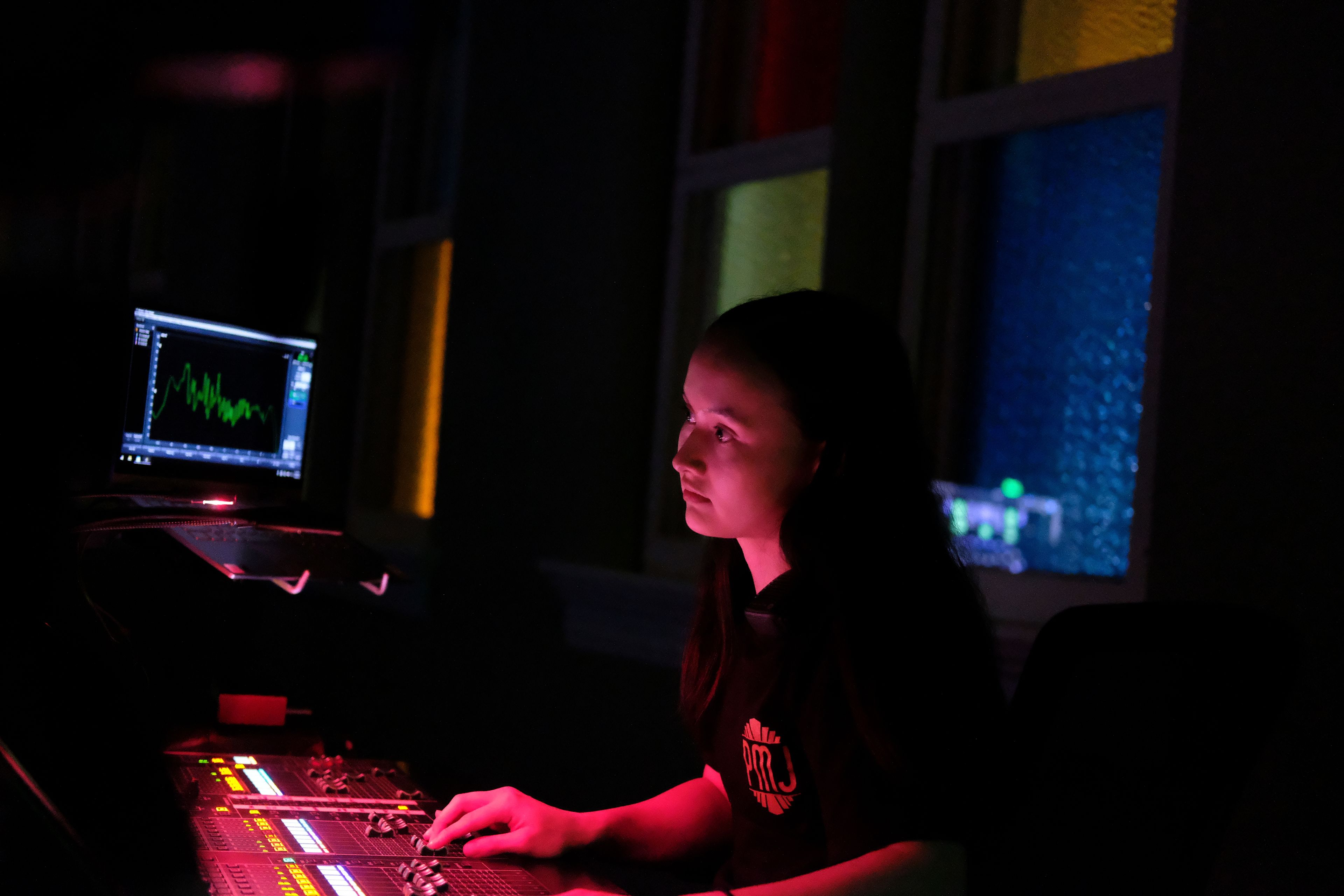 Sound engineer Amber Rhodes prepares before a concert at the Ryman Auditorium in Nashville, Tenn., on July 30, 2024.