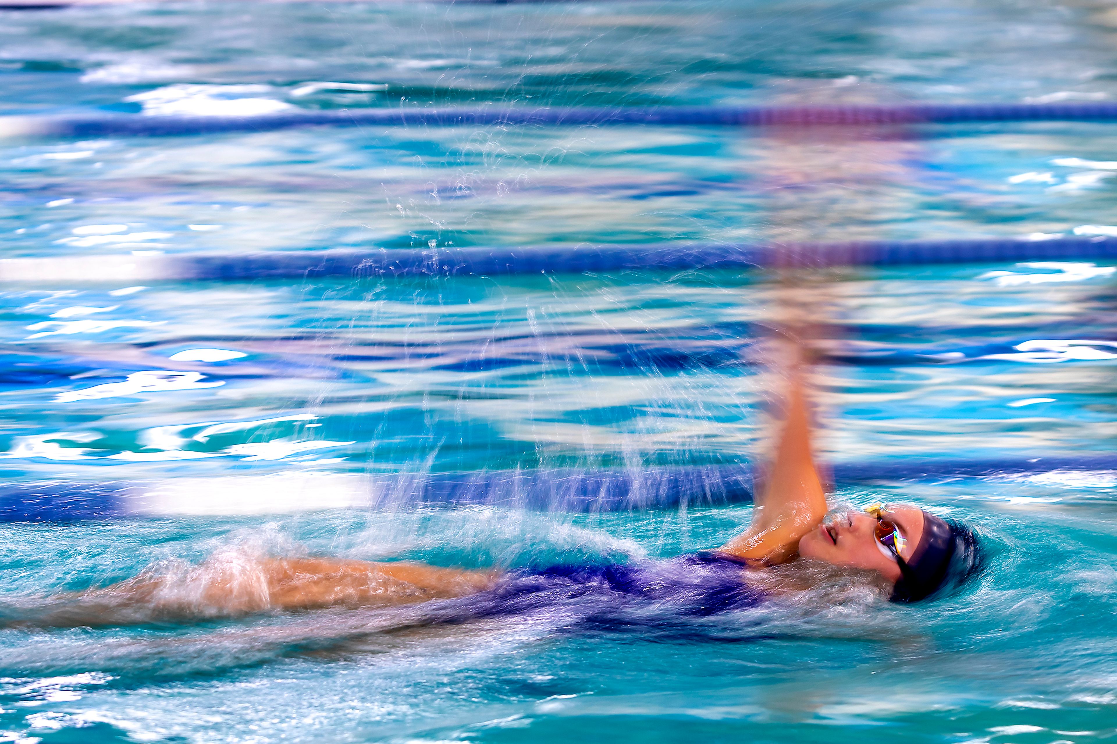 Mya Reed backstrokes through the water at the Pullman Aquatic Center during practice on Wednesday.