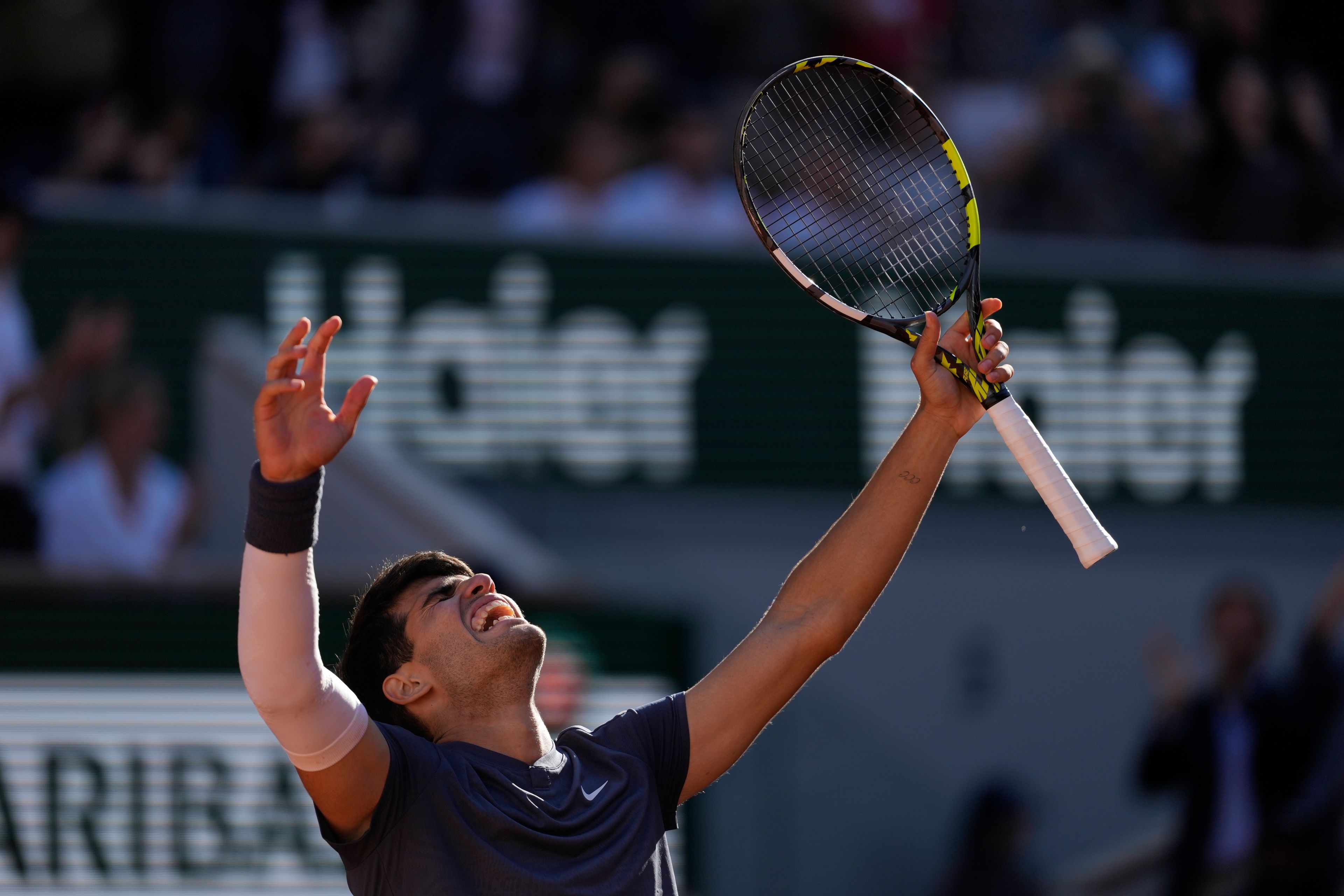 Spain's Carlos Alcaraz celebrates after winning the semifinal match of the French Open tennis tournament against Italy's Jannik Sinner at the Roland Garros stadium in Paris, Friday, June 7, 2024.