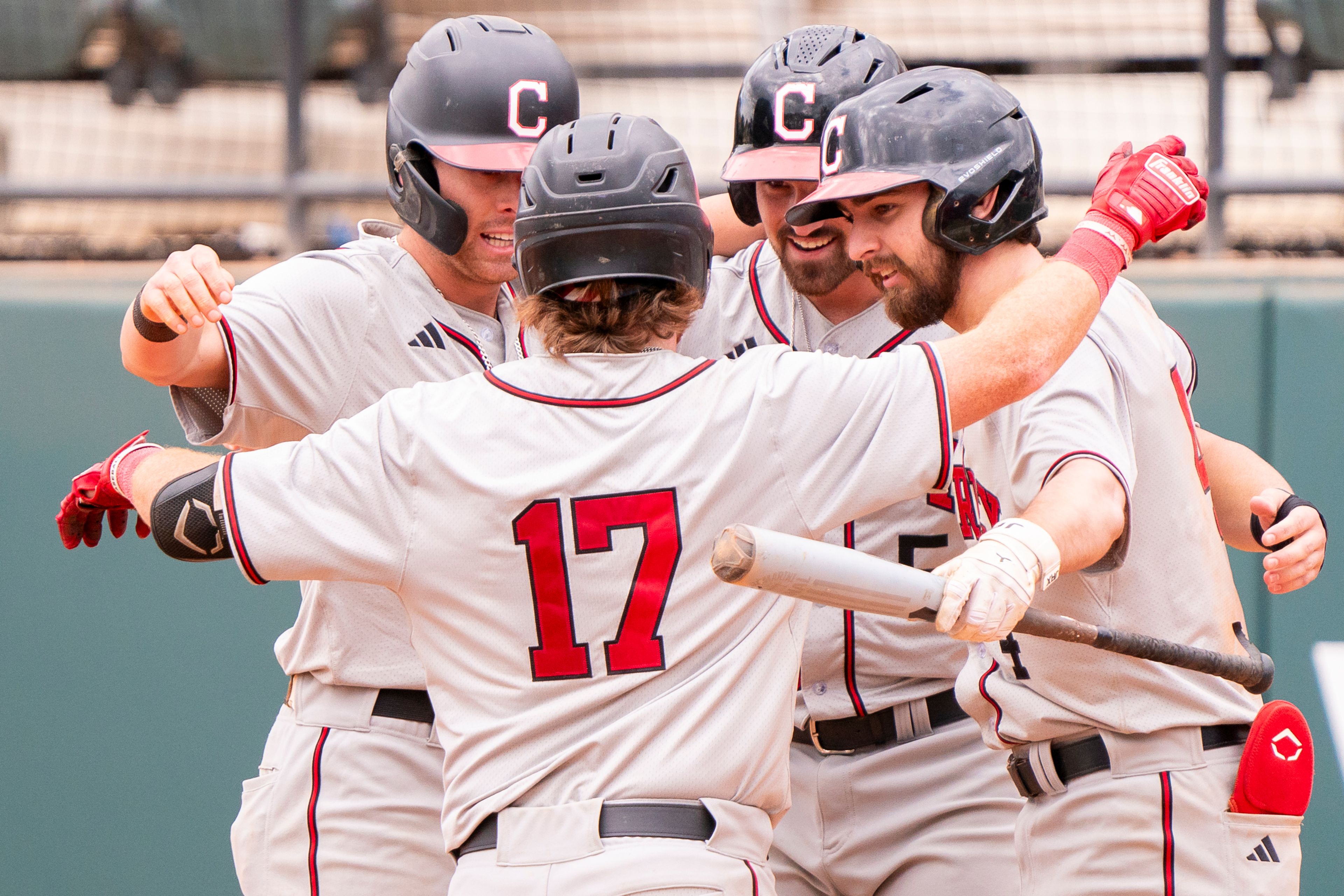 William Carey’s Braydon Coffey (17) celebrates with teammates after hitting a home run during game 6 of the NAIA World Series against Cumberlands on Saturday at Harris Field in Lewiston.