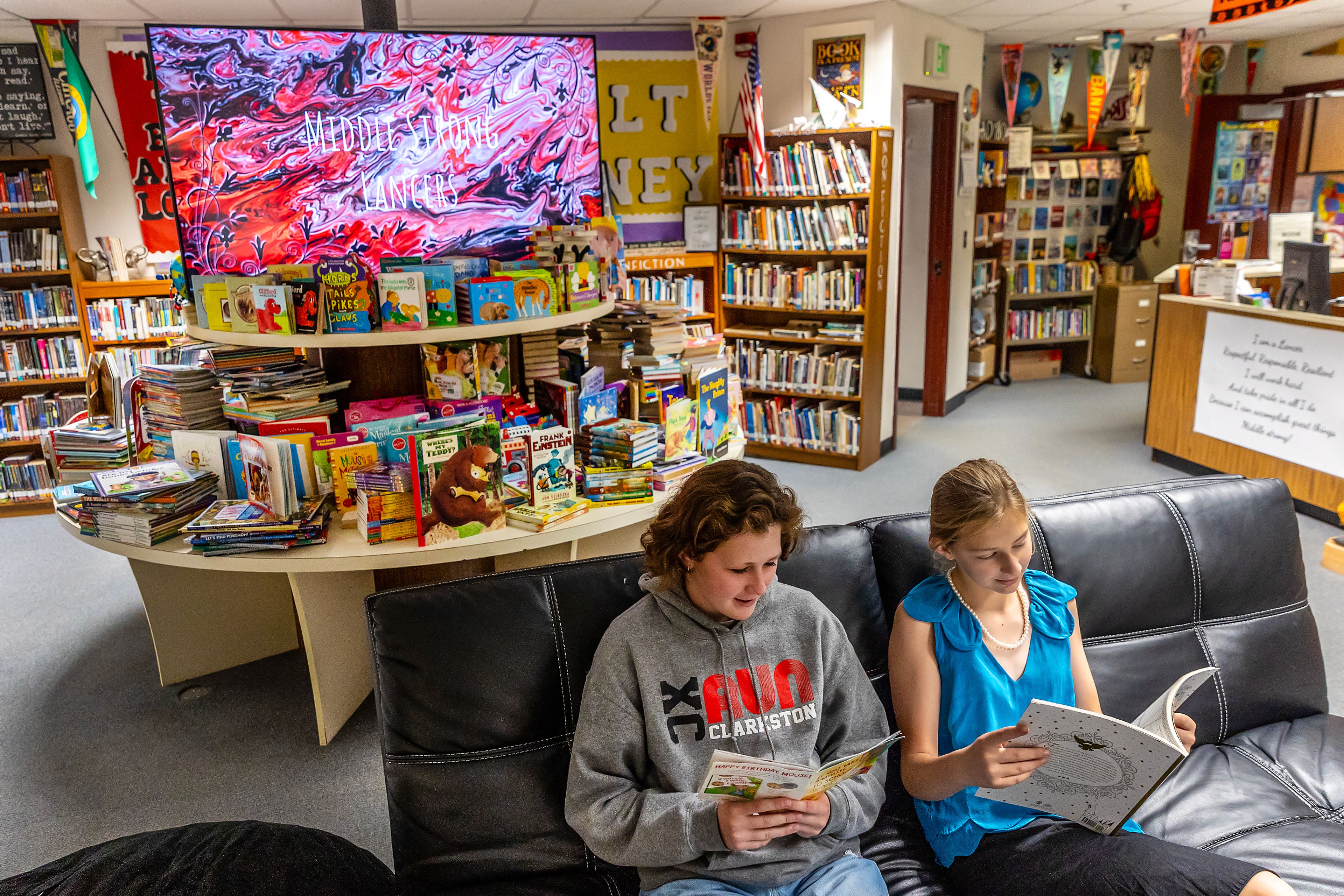 Associated Student Body President Harmony Huff, 13, left, and Edi Breslin, 12, check out some of the 2,262 books, almost double the previous year's total, collected by Lincoln Middle School as more sit on the table behind them Thursday in Clarkston. The school collected the books as part of the Asotin County Library�s 1,000 Books Before Kindergarten program. Breslin brought in the most books in the seventh grade with 289, while Ian Thompson brought in the most books in the eighth grade. The books will go to the Asotin County Library.