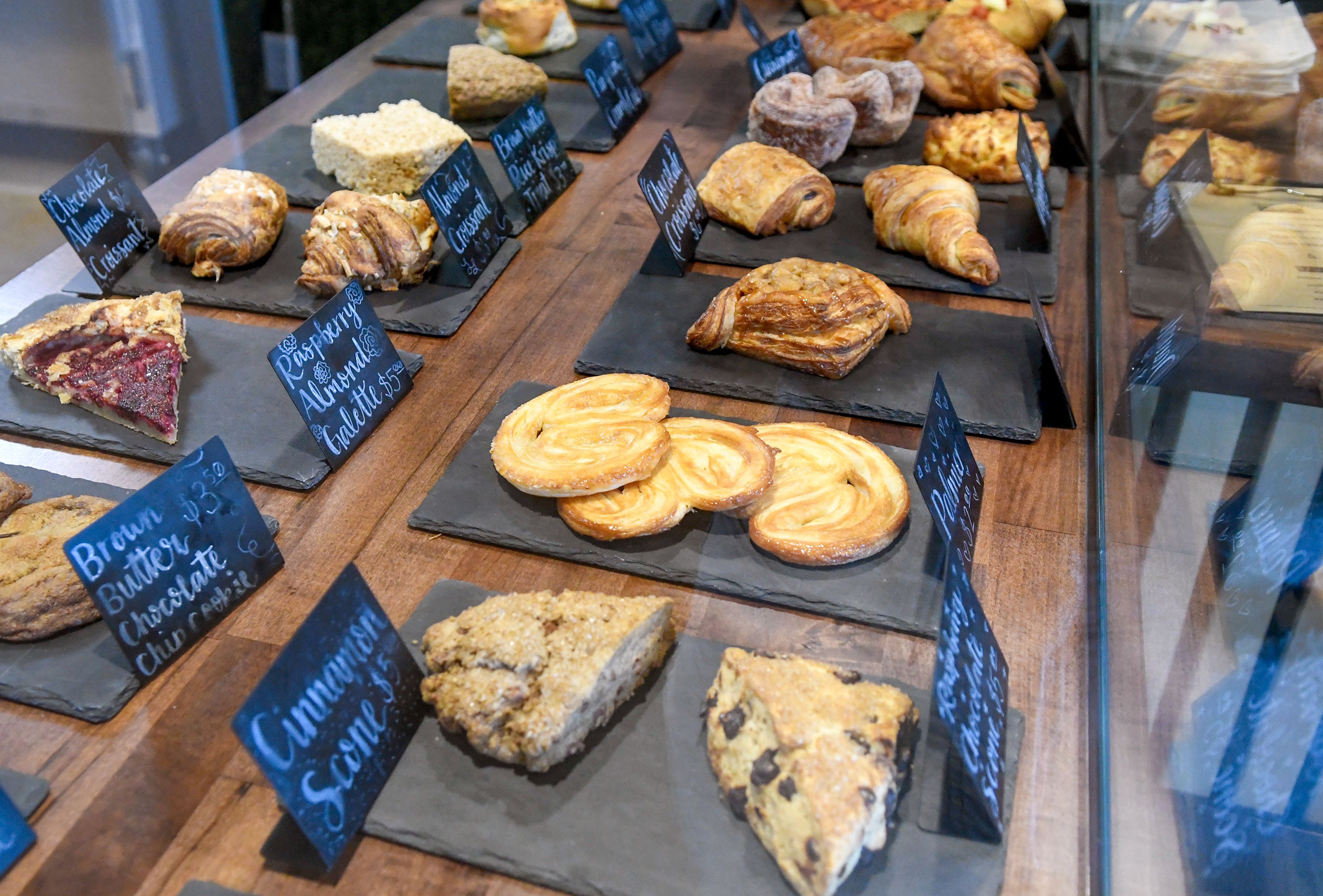 Scones and a variety of other pastries sit in a display case.





