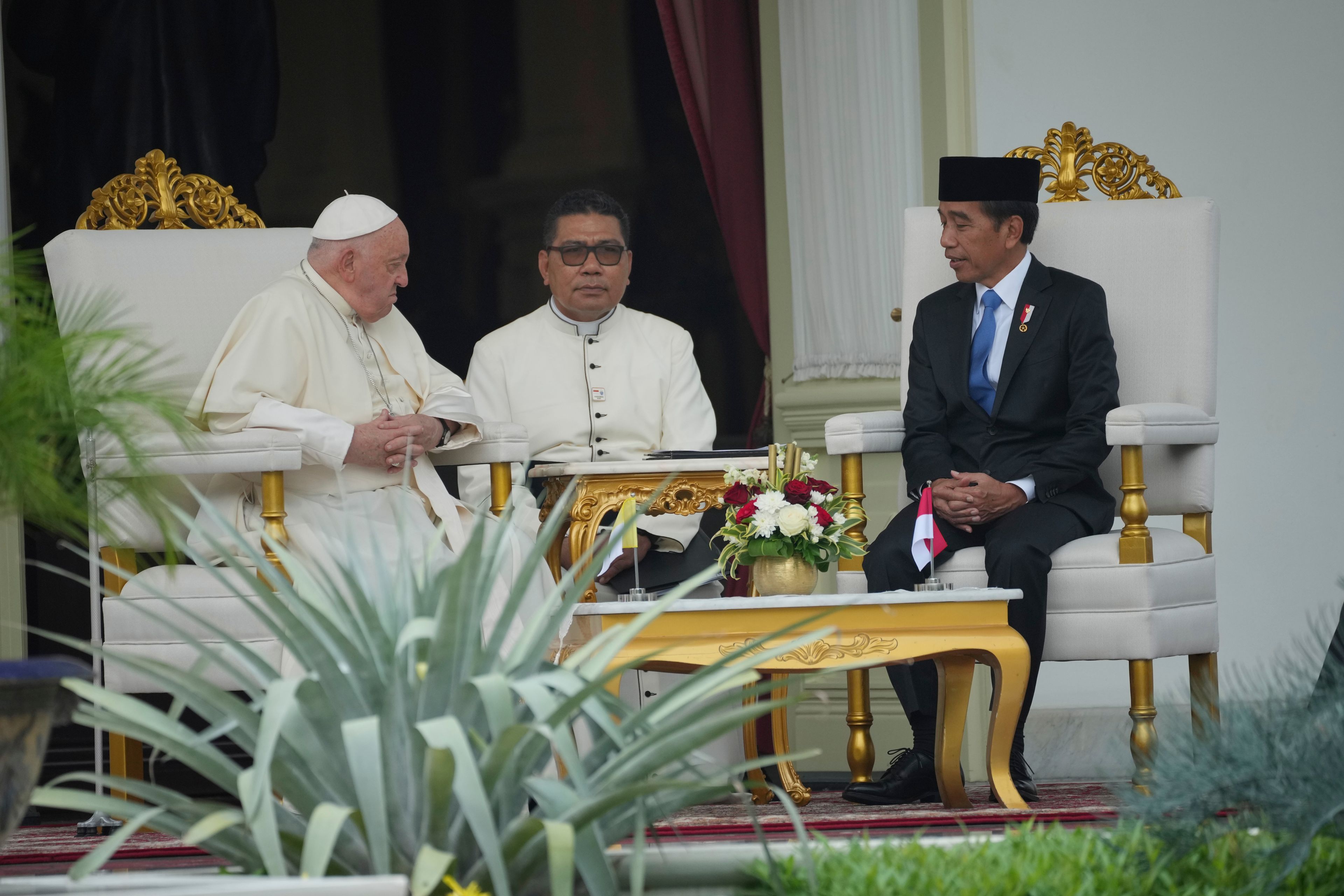 Pope Francis, left, talks with Indonesian President Joko Widodo, right, at the Presidential Palace in Jakarta, Indonesia, Wednesday, Sept. 4, 2024.