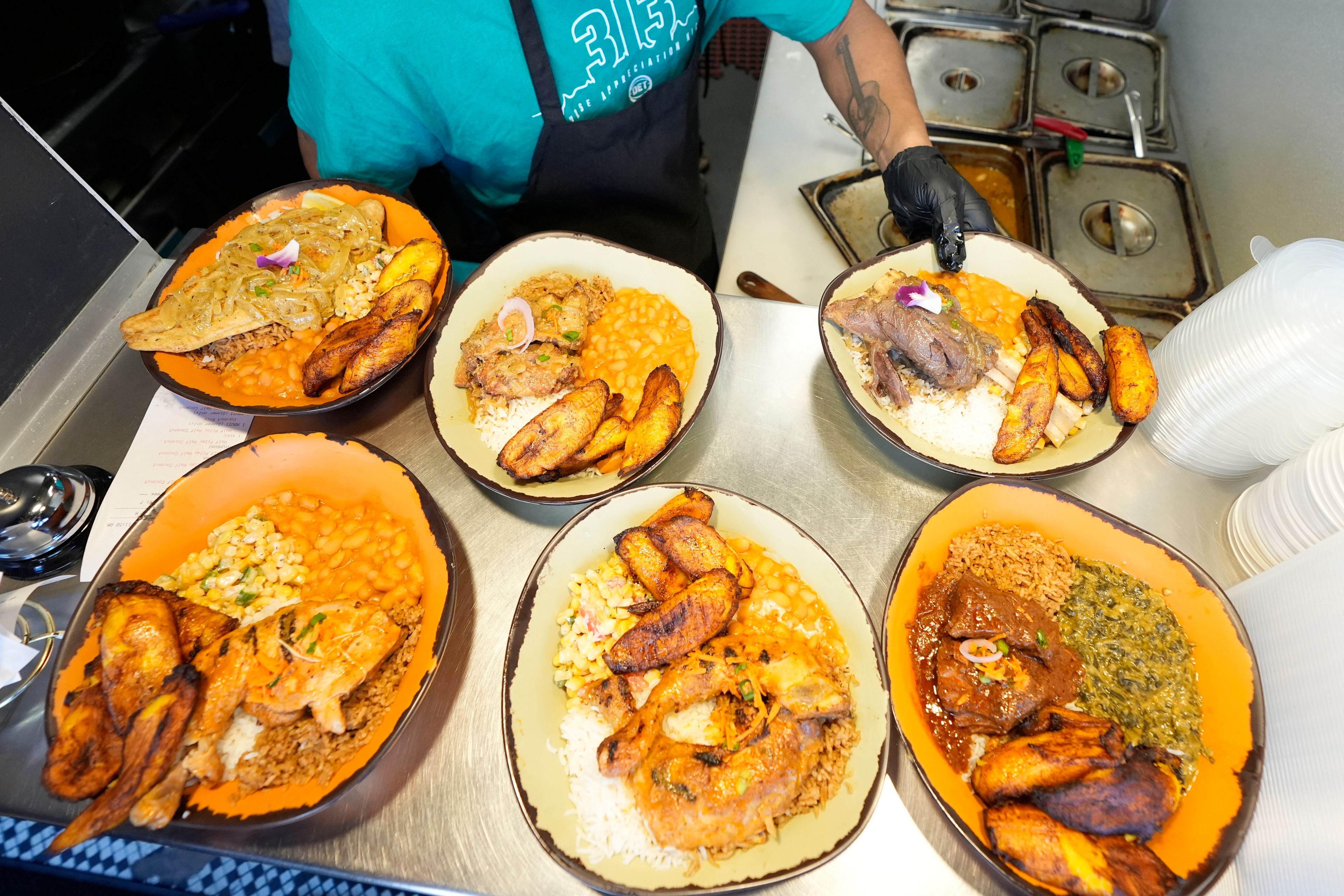 A sampling of East African cuisine is prepared at the Baobab Fare restaurant, Friday, May 24, 2024, in Detroit. For Hamissi Mamba and Nadia Nijimbere _ who own Baobab Fare in Detroit _ a win among the five finalists in the James Beard's "Outstanding Restaurateur" category would be personal. The couple, who fled Burundi about a decade ago, faced a difficult road as refugees opening a business in America.