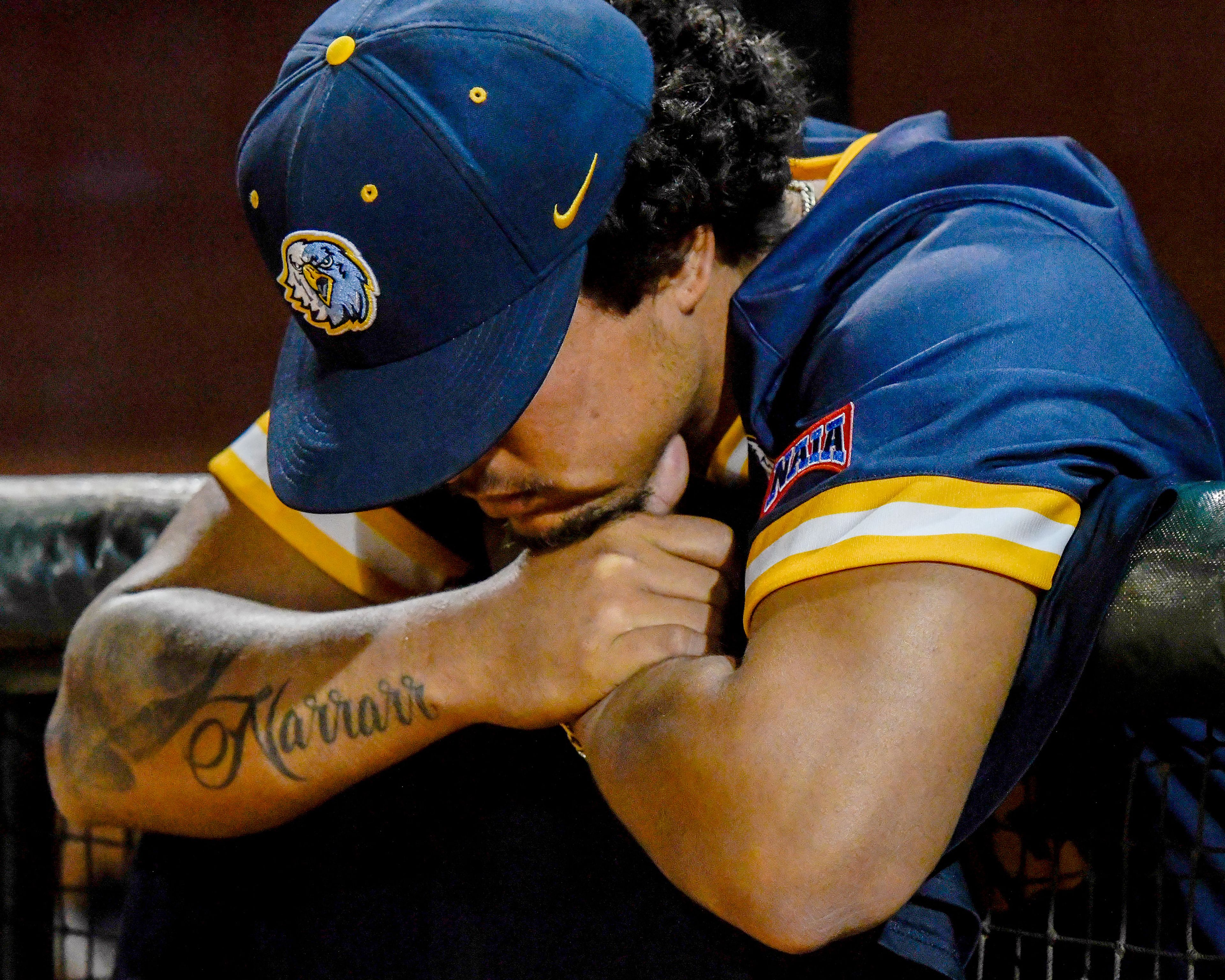 Reinhardt’s Richard Castro hangs his head over the edge of the dugout after the team’s loss to Tennessee Wesleyan in Game 18 of the NAIA World Series at Harris Field in Lewiston on Thursday.