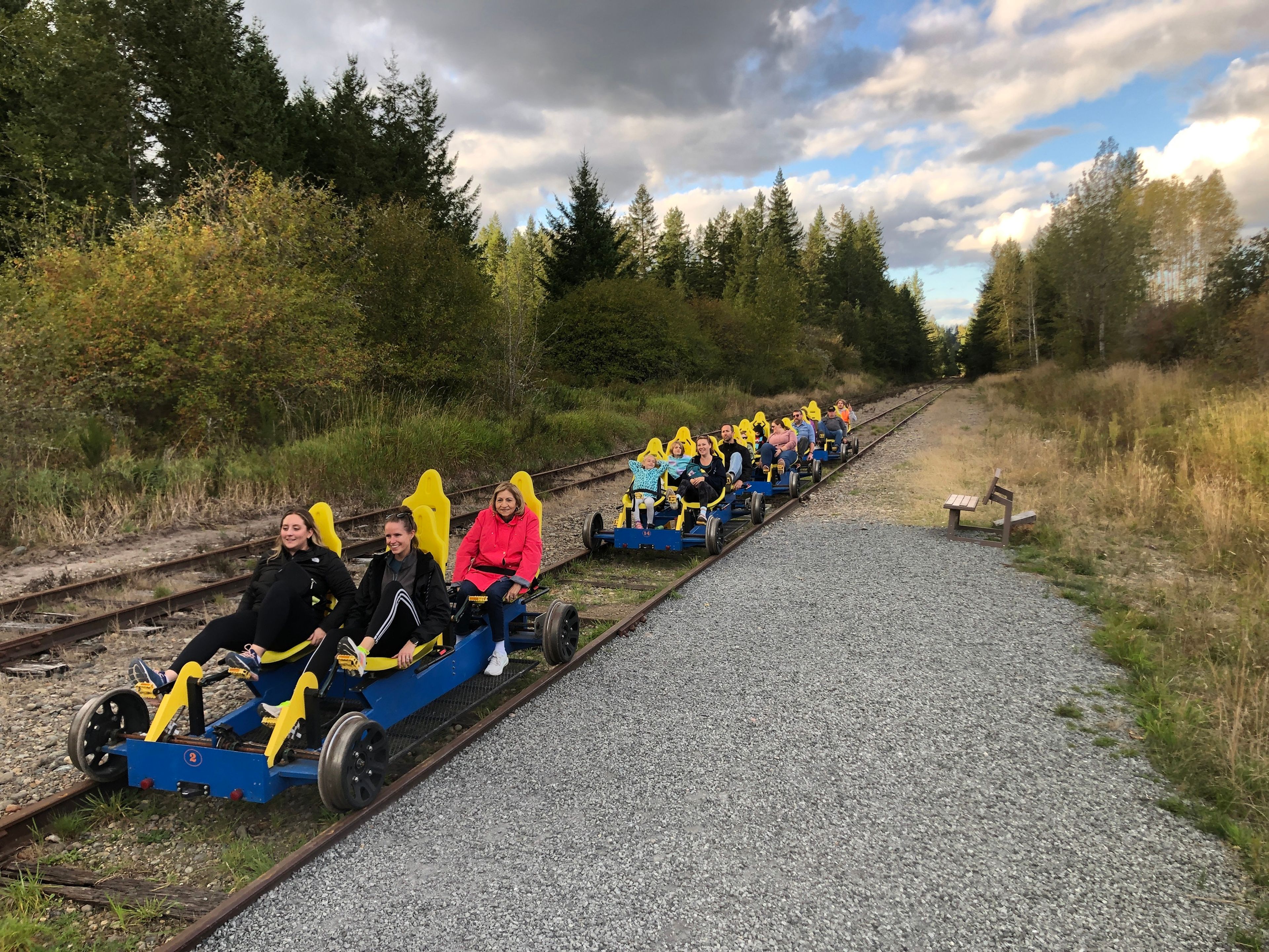 A group on a RailCycle excursion returns after pedaling a little more than 1.5 miles uphill at a 2% grade, with guide Frank Amon in the orange reflective vest bringing up the rear to ensure everyone makes it back. 