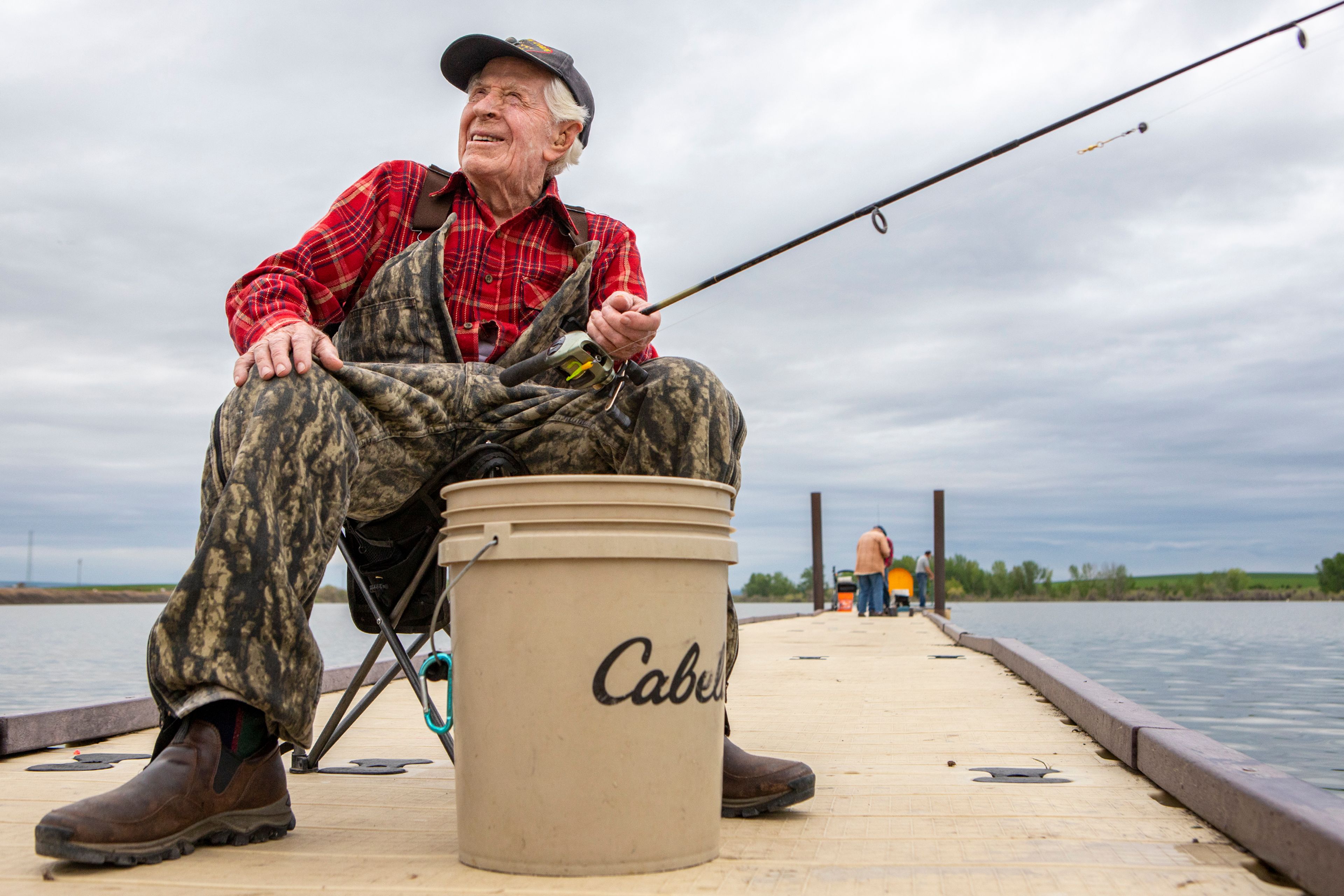 Paul Sauder enjoys some morning fishing Wednesday at Mann Lake in the Lewiston Orchards. Sauder, who is 98, fishes off this dock a few times a week.