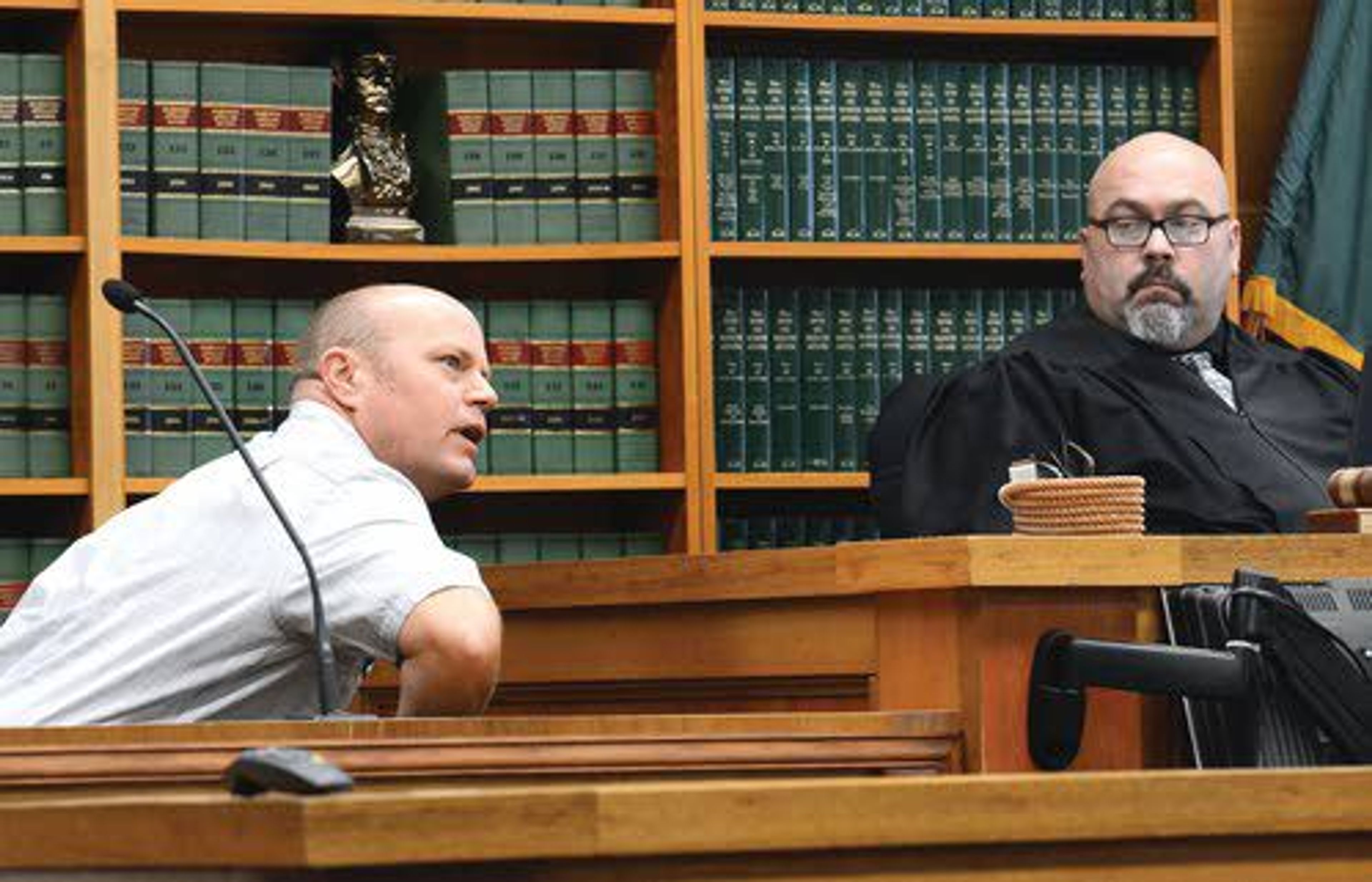 Superior Court Judge Scott D. Gallina listens to the testimony of Brady O’Kelley on Thursday as he demonstrates what occured during an altercation in May with Bernie McCabe at Early Bird Supply in Clarkston.