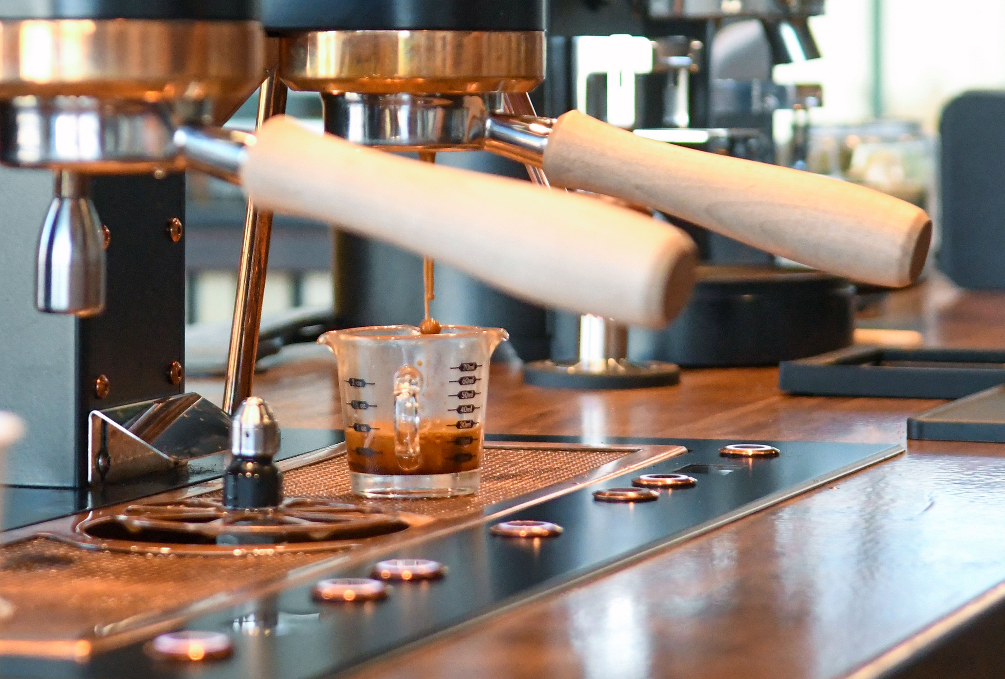 Espresso pours from an espresso machine at Knead Cafe & Patisserie. 