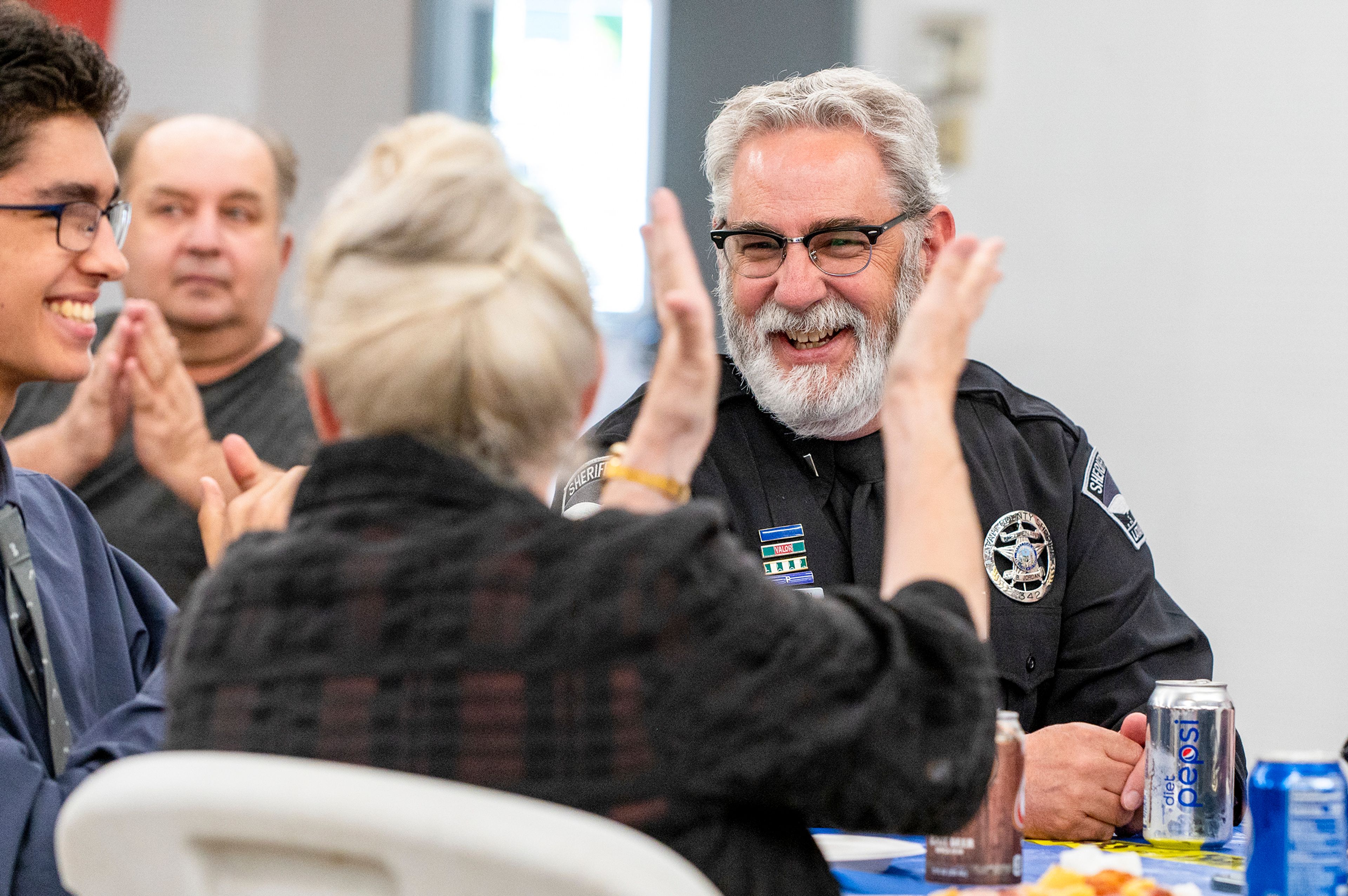 Lt. Brannon Jordan is applauded as members of the Latah County Sheriff’s Office share stories about Jordan’s time with the department during his retirement party Thursday.