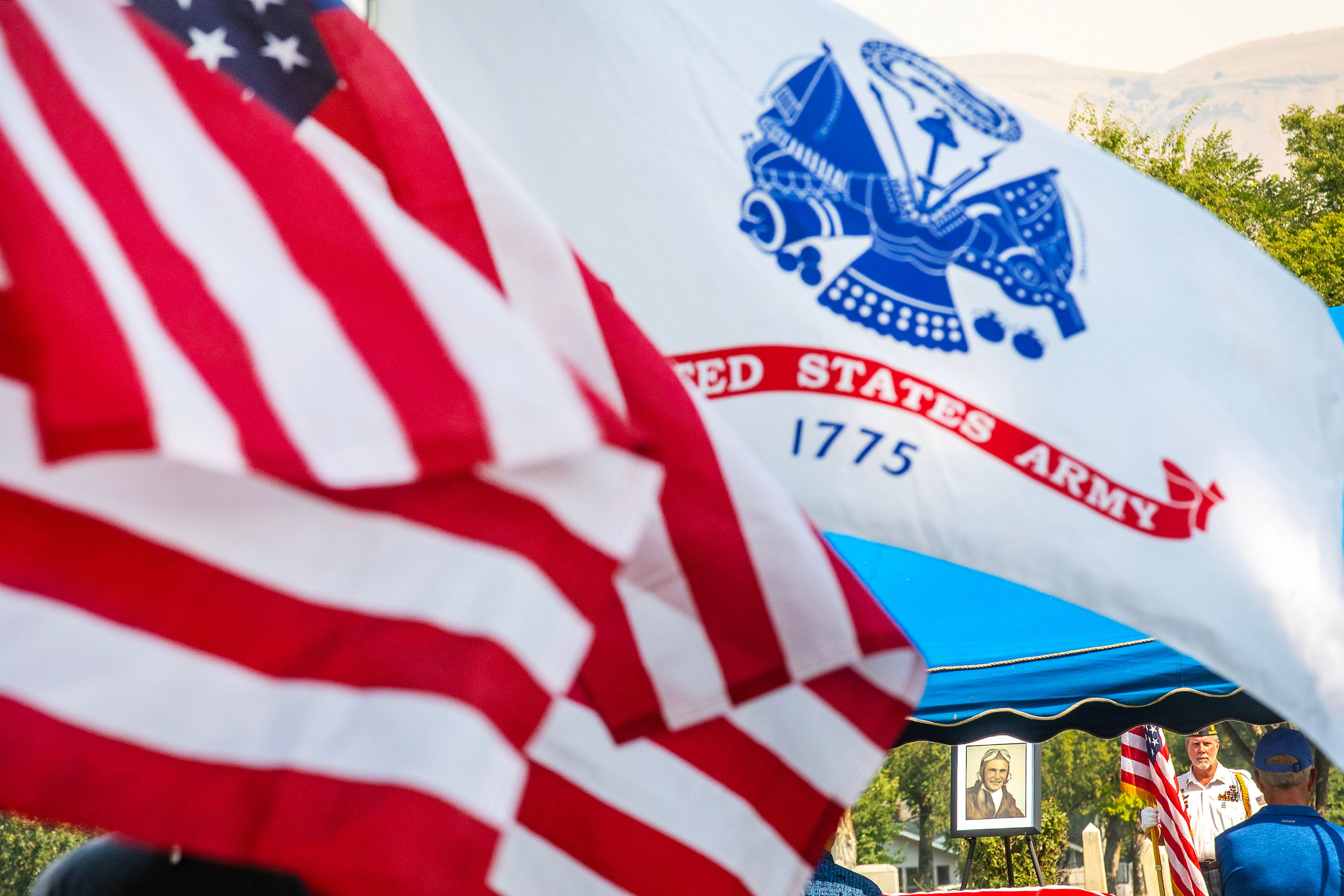 Flags wave in the breeze at the funeral for Allan Knepper Thursday at the Normal Hill Cemetery in Lewiston.