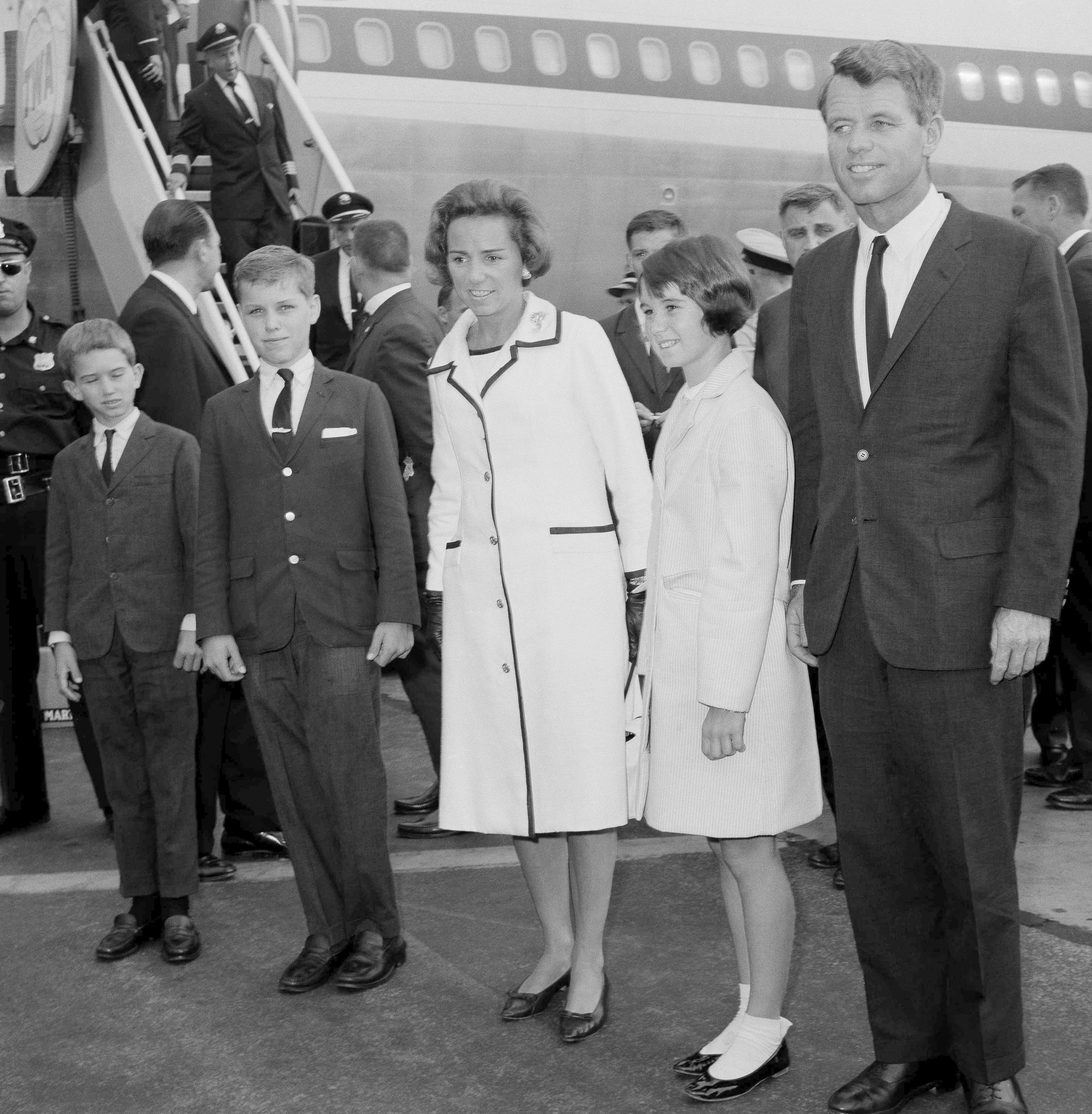 FILE - Attorney General Robert F. Kennedy, right, wife Ethel Kennedy, and children, from left, Bobby, Joseph, and Kathleen, second right, pose at Kennedy International Airport in New York, July 1, 1964, shortly after they returned from a one-week trip to West Germany and Poland. (AP Photo/Matty Zimmerman, File)