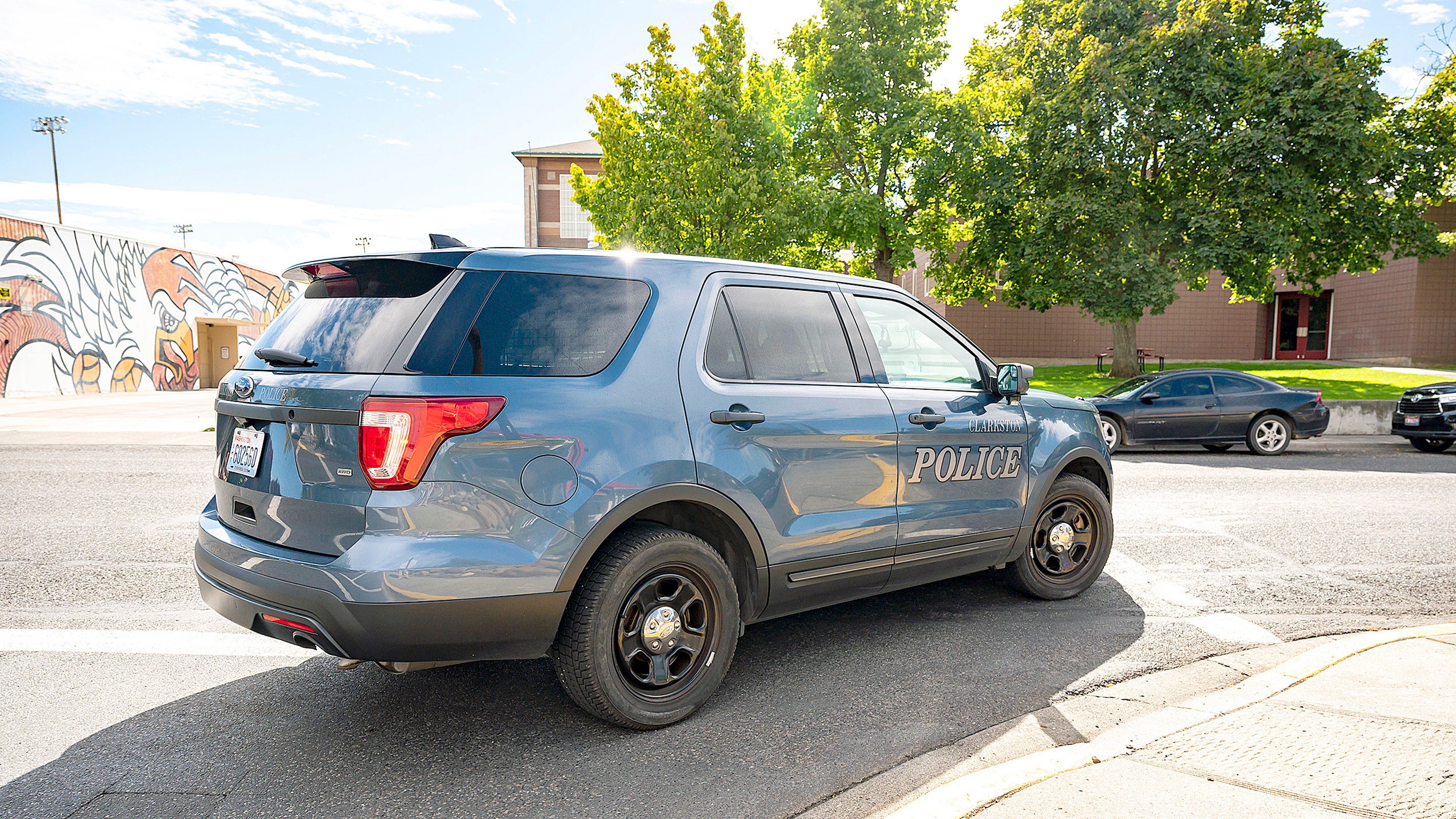 A Clarkston police car patrols the area around Clarkston High School after a high-speed pursuit was called off near the area on Tuesday afternoon. Police were still looking for the suspect as of Tuesday evening.