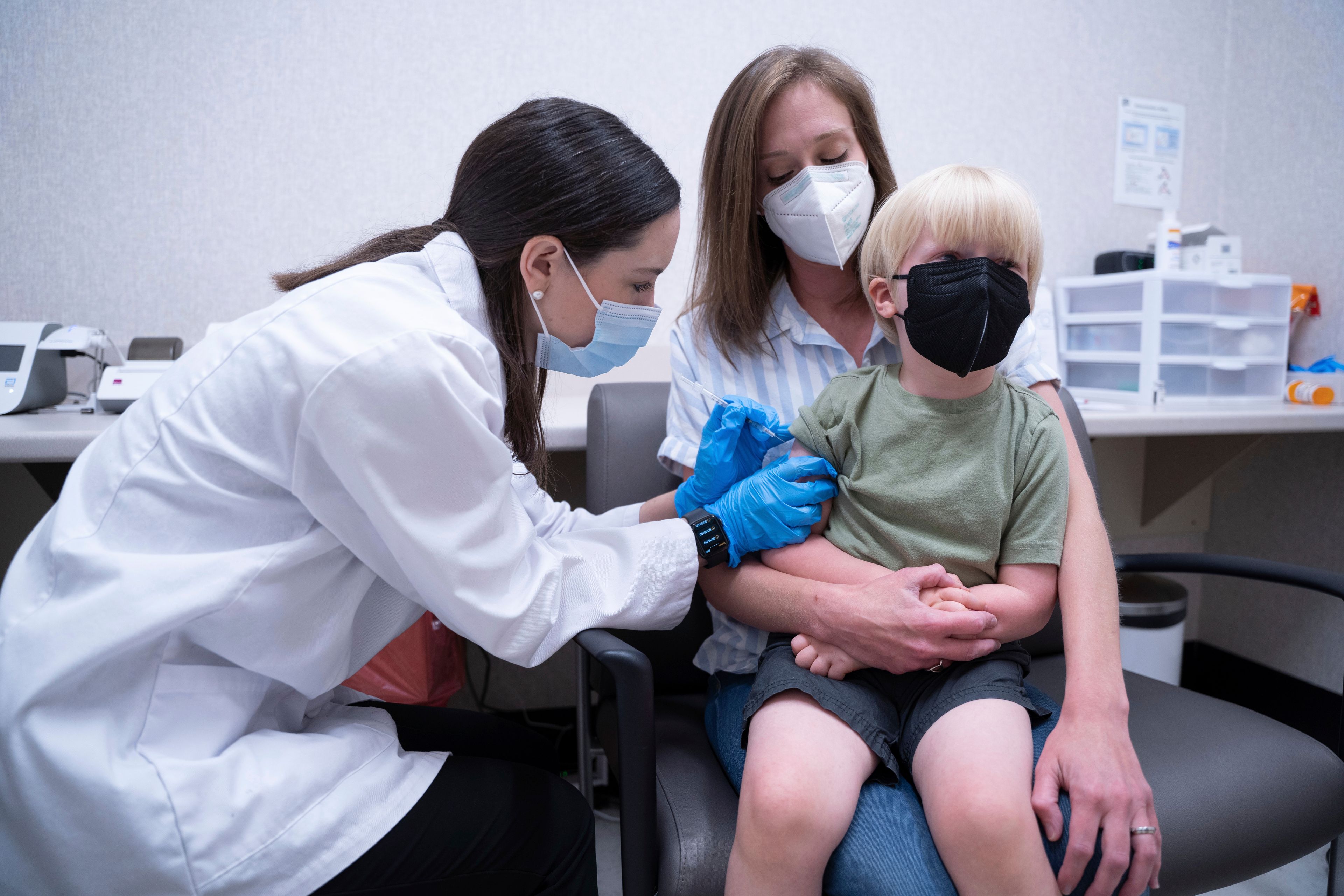 Pharmacist Kaitlin Harring administers a Moderna COVID-19 vaccination Monday to three-year-old Fletcher Pack. He’s held by his mother, McKenzie Pack, at a Walgreens pharmacy in Lexington, S.C.