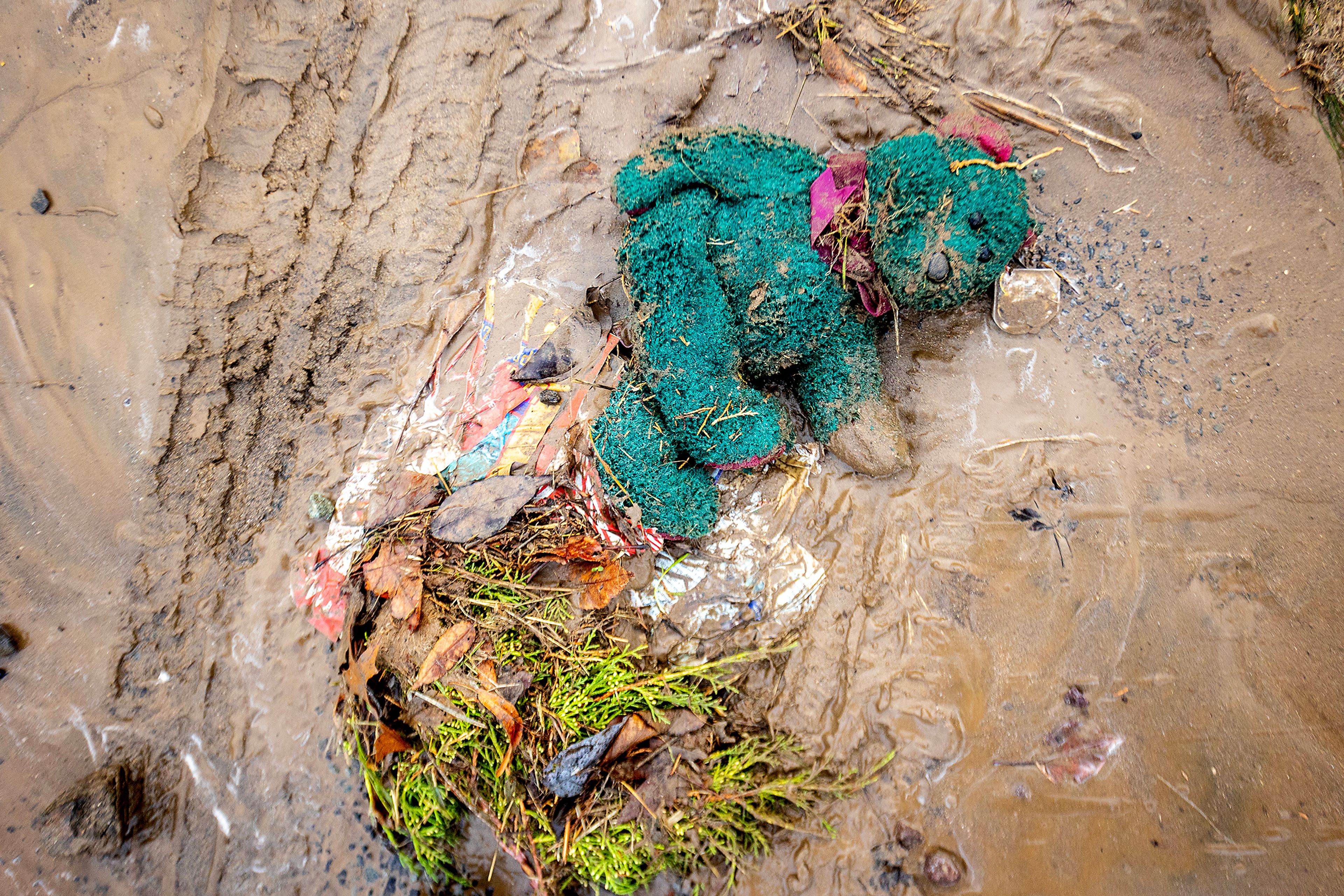 A stuffed teddy bear sits in the mud after a water reservoir at the corner of 16th Avenue and 29th Street burst in the early hours of Wednesday morning in Lewiston.