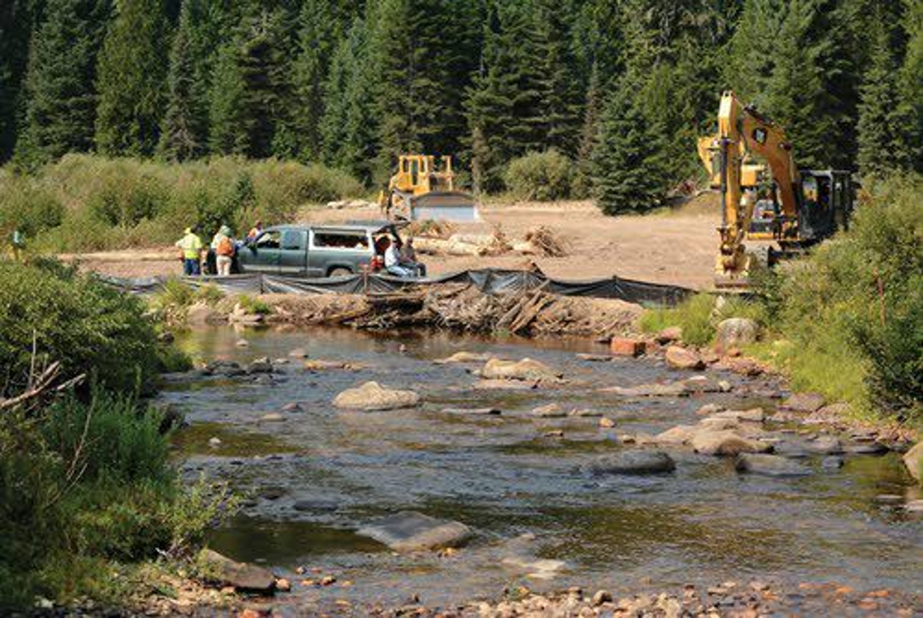 ABOVE: Much of the effort to save Snake River salmon and steelhead populations has focused on watershed restoration such as this project to fix flood plain problems on Lolo Creek.LEFT: John and Stephanie Hunter watch a steelhead from the fish viewing window at Lower Granite Dam recently.