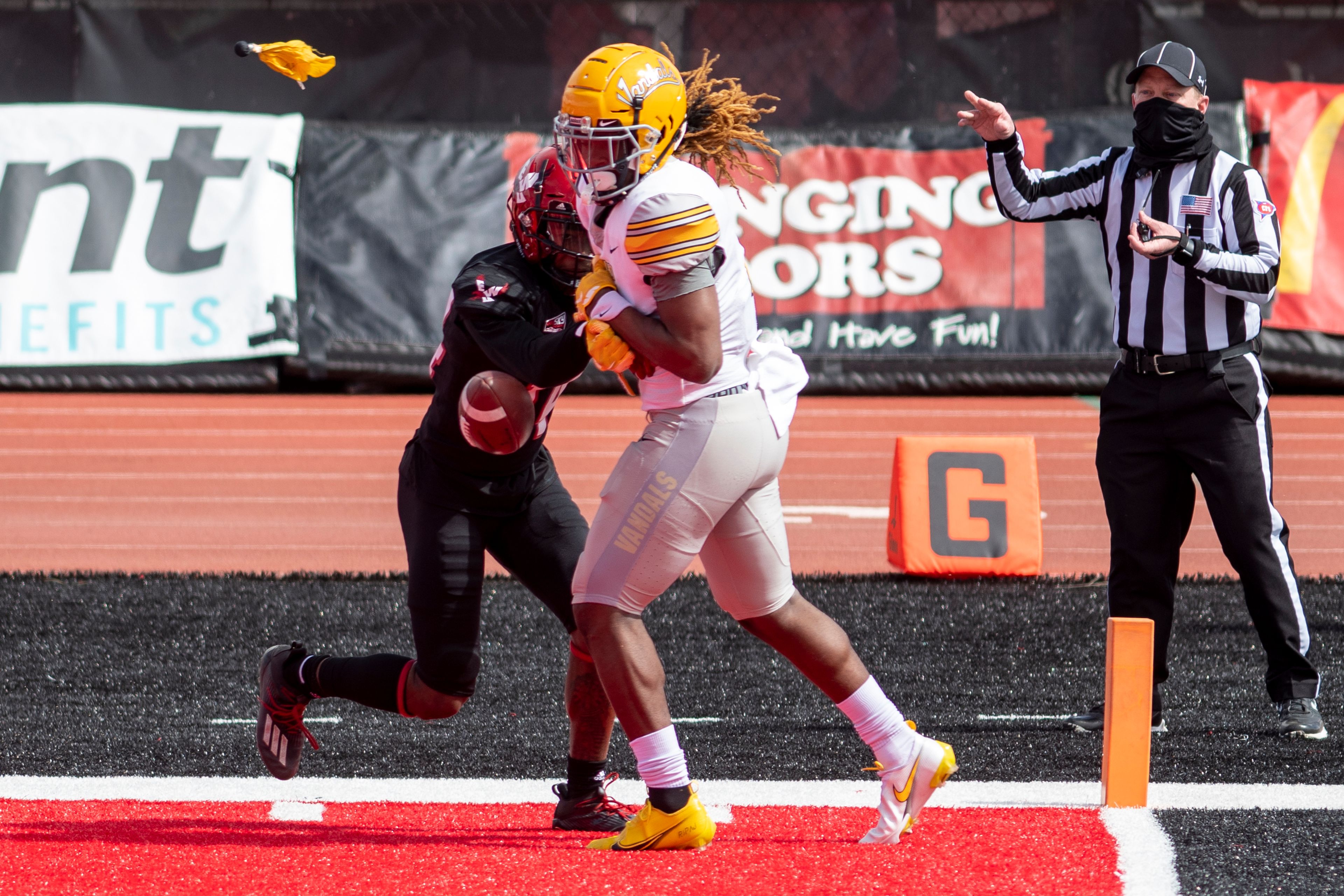 A flag is thrown for pass interference as Idaho wide receiver Cutrell Haywood (7) attempts to bring in a pass against Eastern Washington defensive back Darrien Sampson (14) during the first quarter of a Big Sky Conference matchup at Roos Field on Saturday afternoon. Eastern Washington defeated Idaho 38-31.