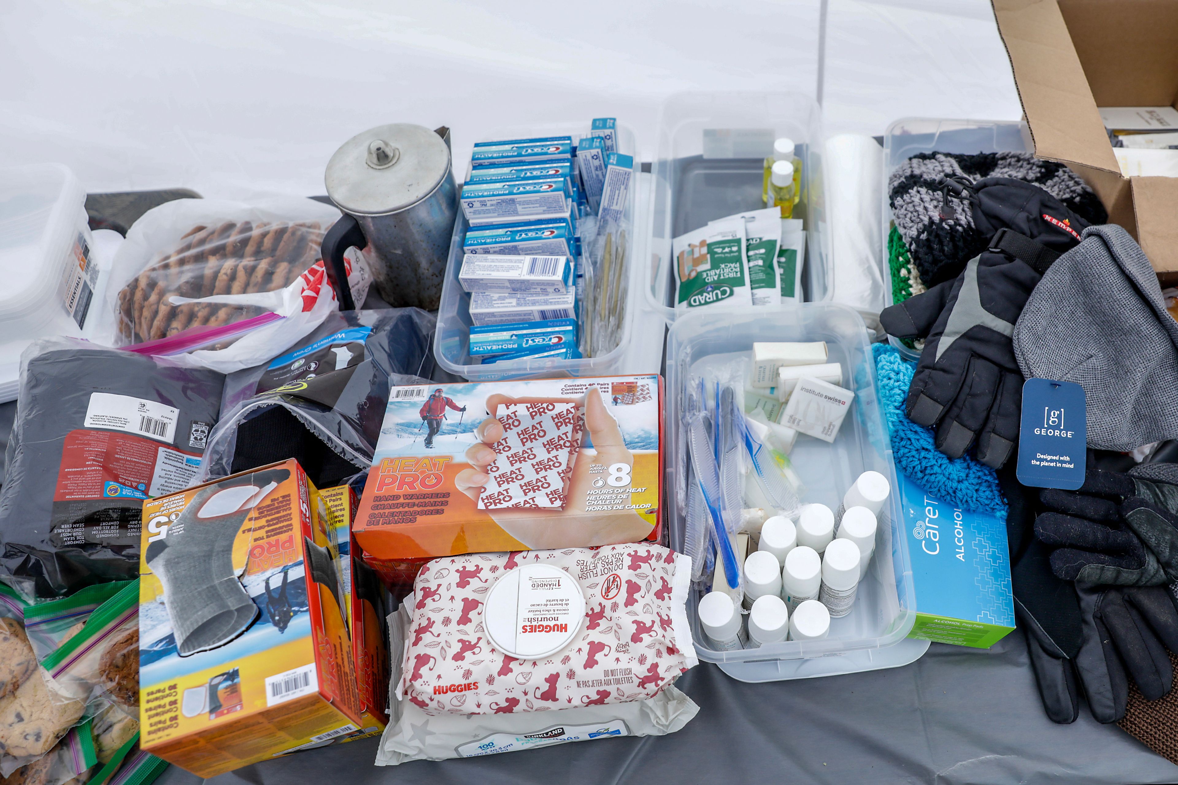 Supplies sit on a table for residents of the homeless camp behind Walmart at a warming tent outside the Chef Store Sunday in Clarkston.