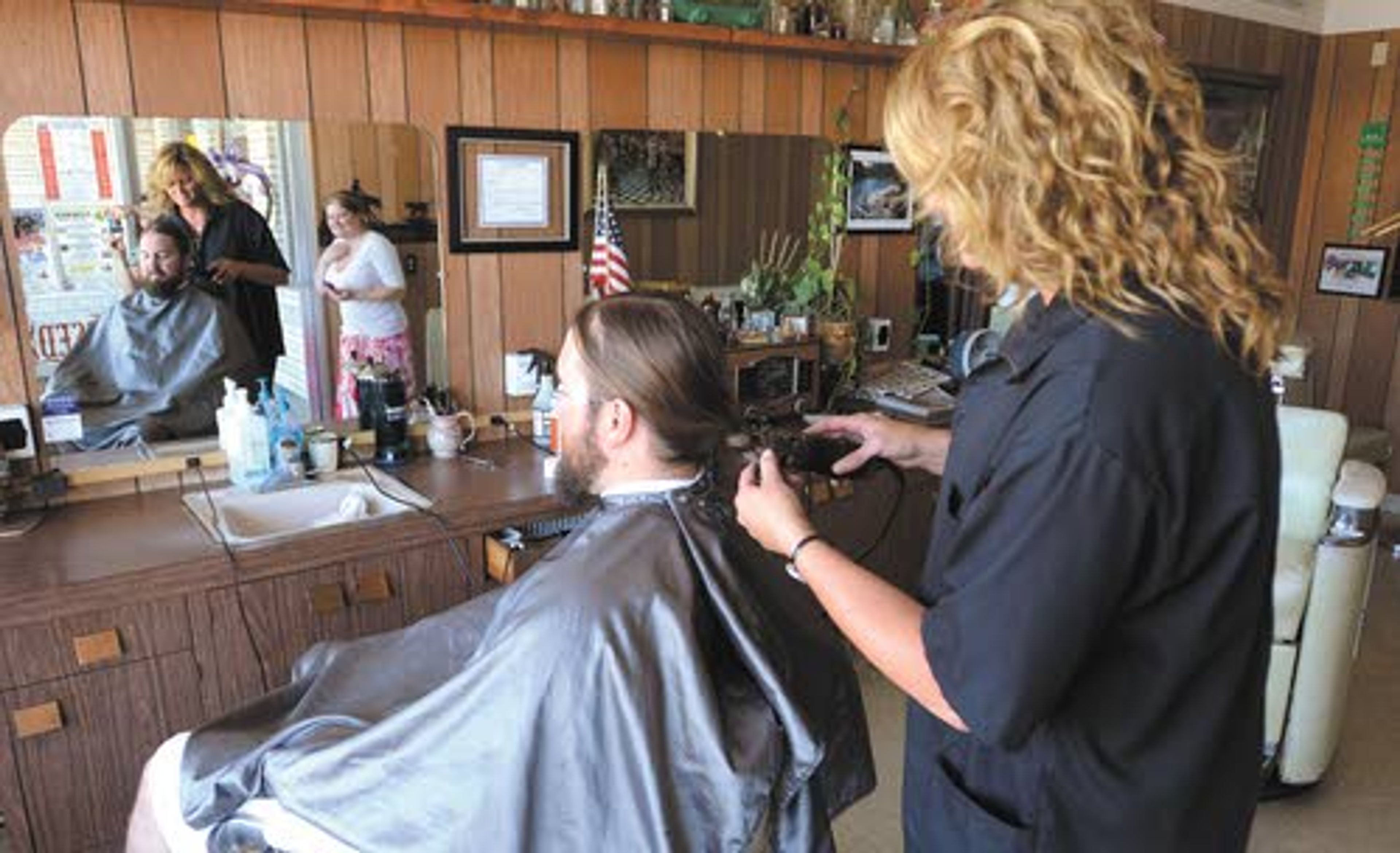 The moment of truth as my barber Sally Salas puts the clippers
to my braid.