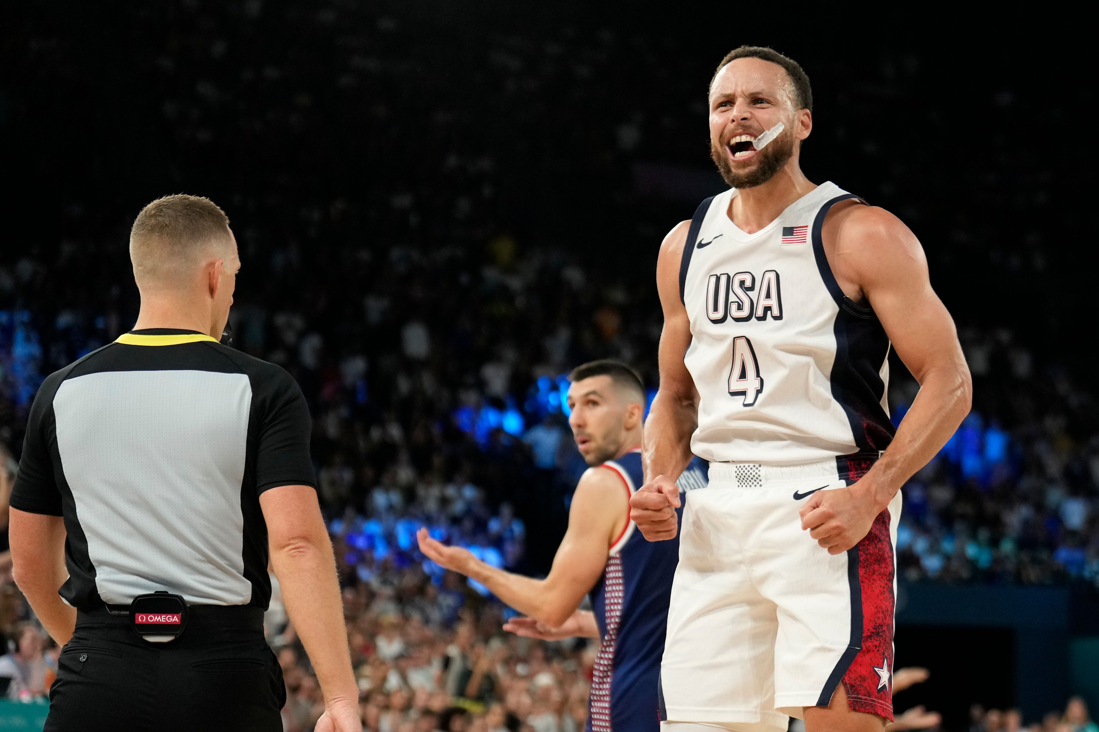 United States' Stephen Curry (4) celebrates a basket in the final minutes against Serbia during a men's semifinals basketball game at Bercy Arena at the 2024 Summer Olympics, Thursday, Aug. 8, 2024, in Paris, France. (AP Photo/Mark J. Terrill)