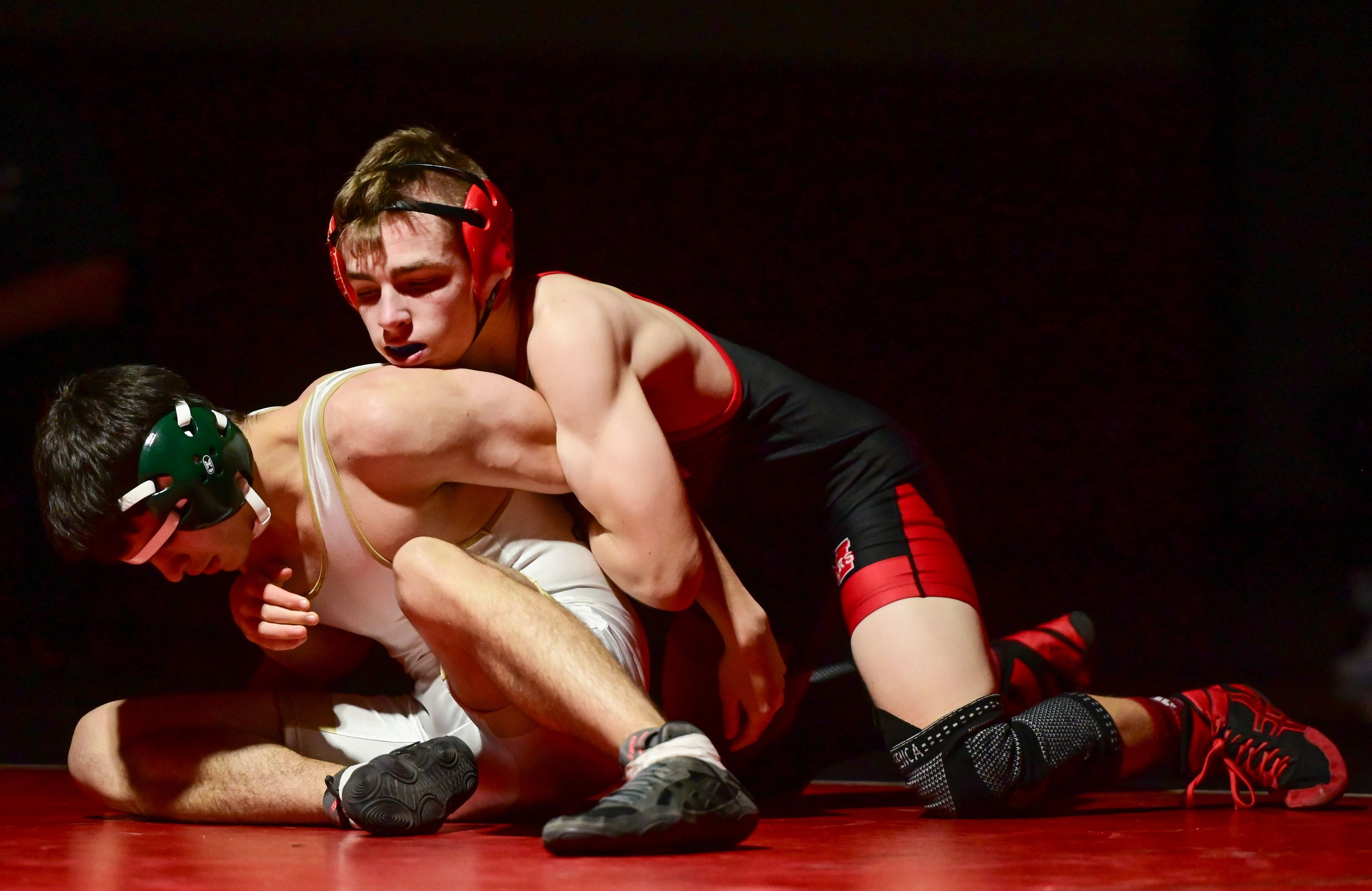 Moscow’s Marcus Swift pushes St. Maries’ Michael Stewart to the mat during a match Thursday at Bear Den in Moscow.