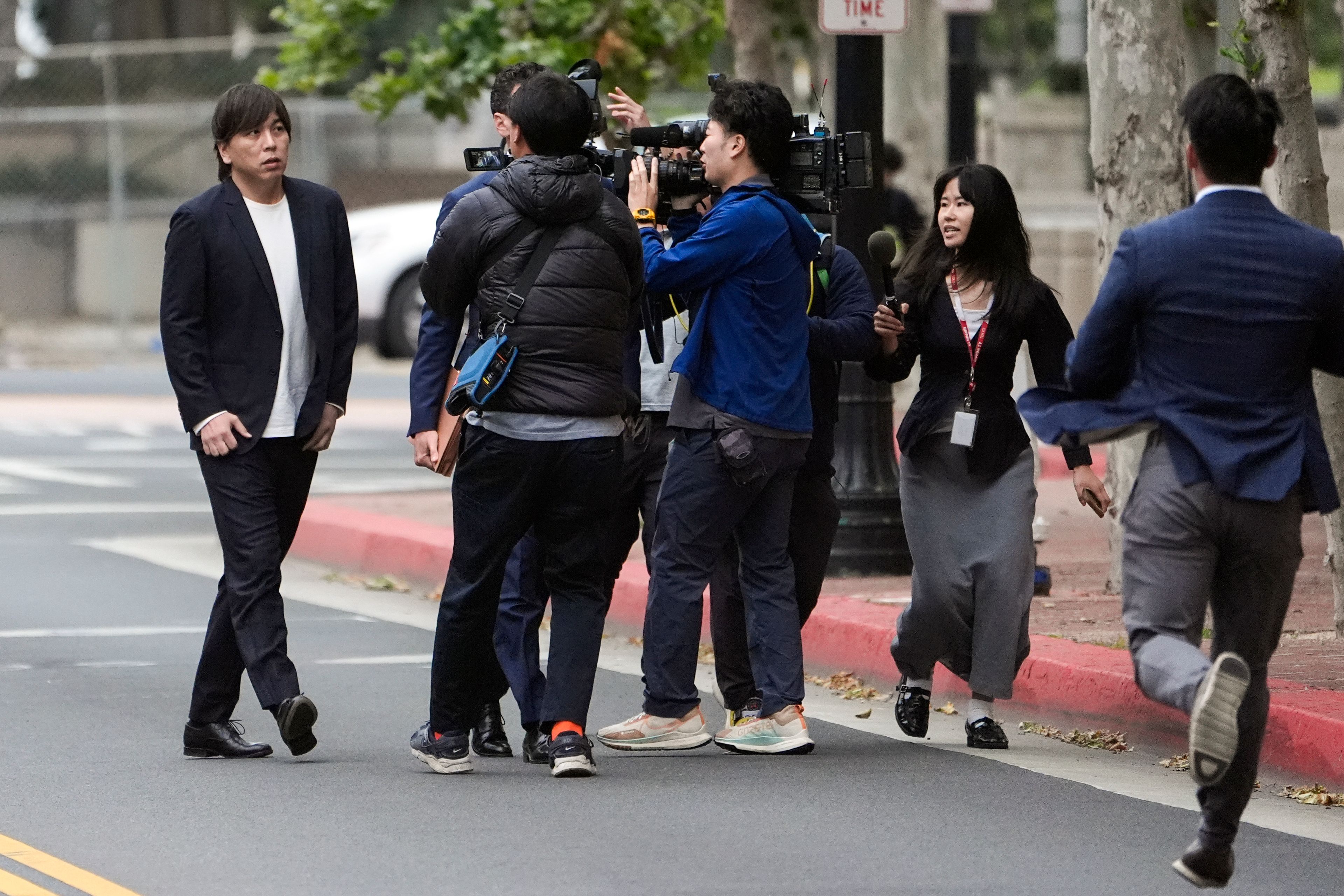 Ippei Mizuhara, left, the former interpreter for the Los Angeles Dodgers baseball star Shohei Ohtani, arrives at federal court in Los Angeles, Tuesday, June 4, 2024. Mizuhara pleaded guilty to bank and tax fraud on Tuesday and admitted to stealing nearly $17 million from the Japanese baseball player to pay off sports betting debts. AP Photo/Damian Dovarganes)