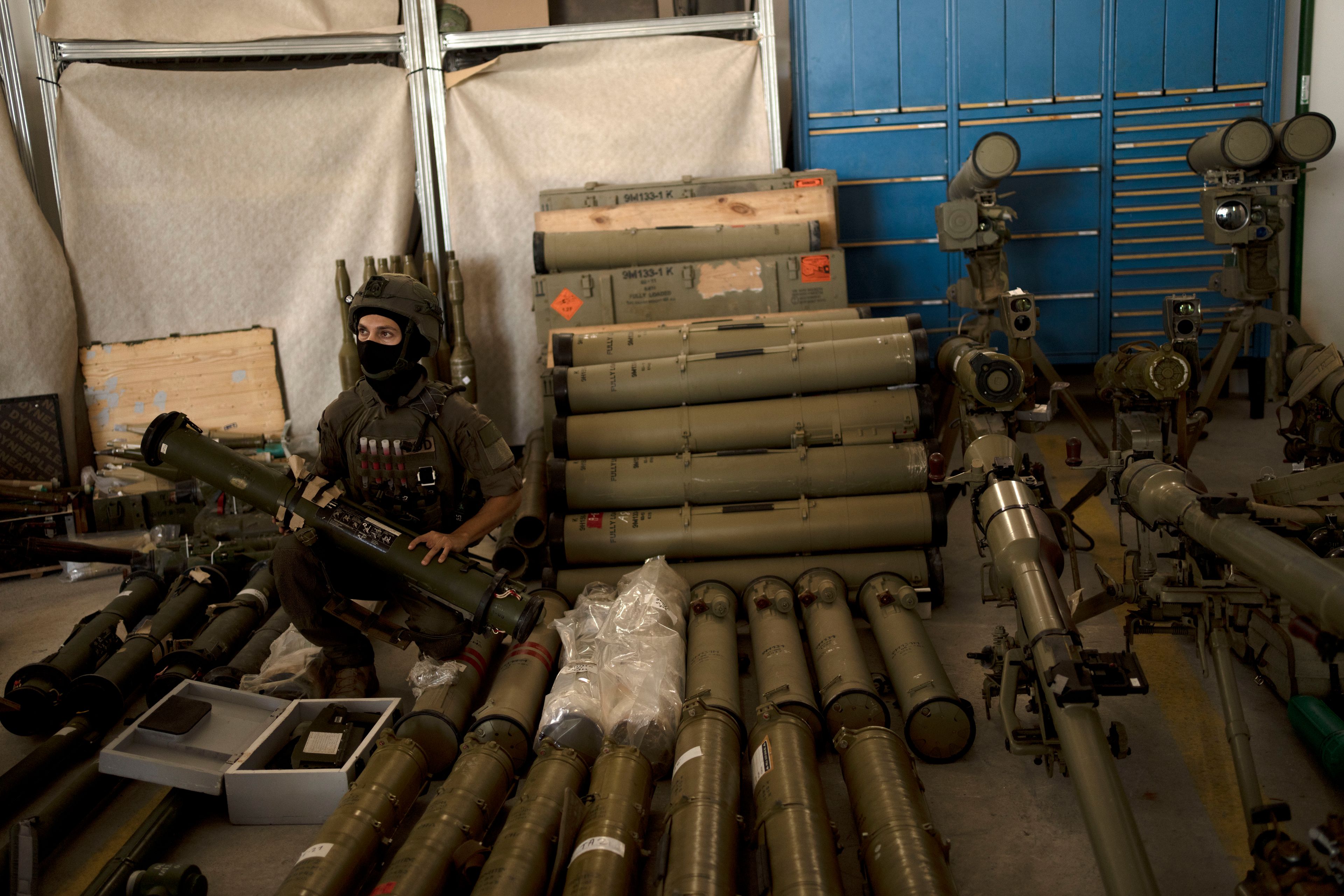 An Israeli soldier from an EOD (explosive ordnance disposal) poses with a weapon used by Hezbollah seized during combat operations in Lebanon displayed during a government-organized media tour on a base in southern Israel, Wednesday, Oct. 9, 2024. (AP Photo/Maya Alleruzzo)