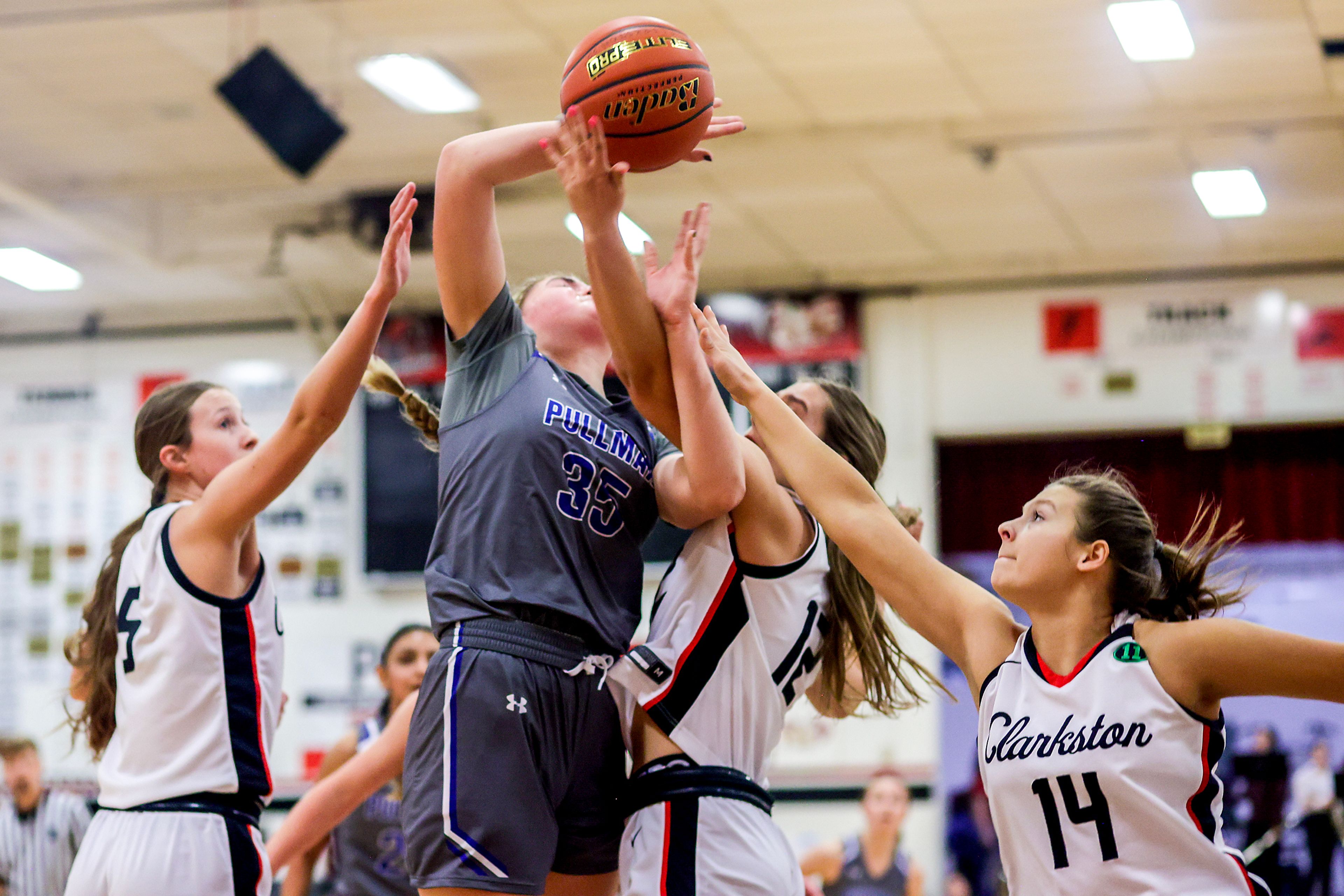 Pullman post Ryliann Bednar, second from left, attempts to shoot under pressure from Clarkston wing Ryann Combs and wing Taryn Demers, right, during Tuesday's Class 2A Greater Spokane League girls basketball game.