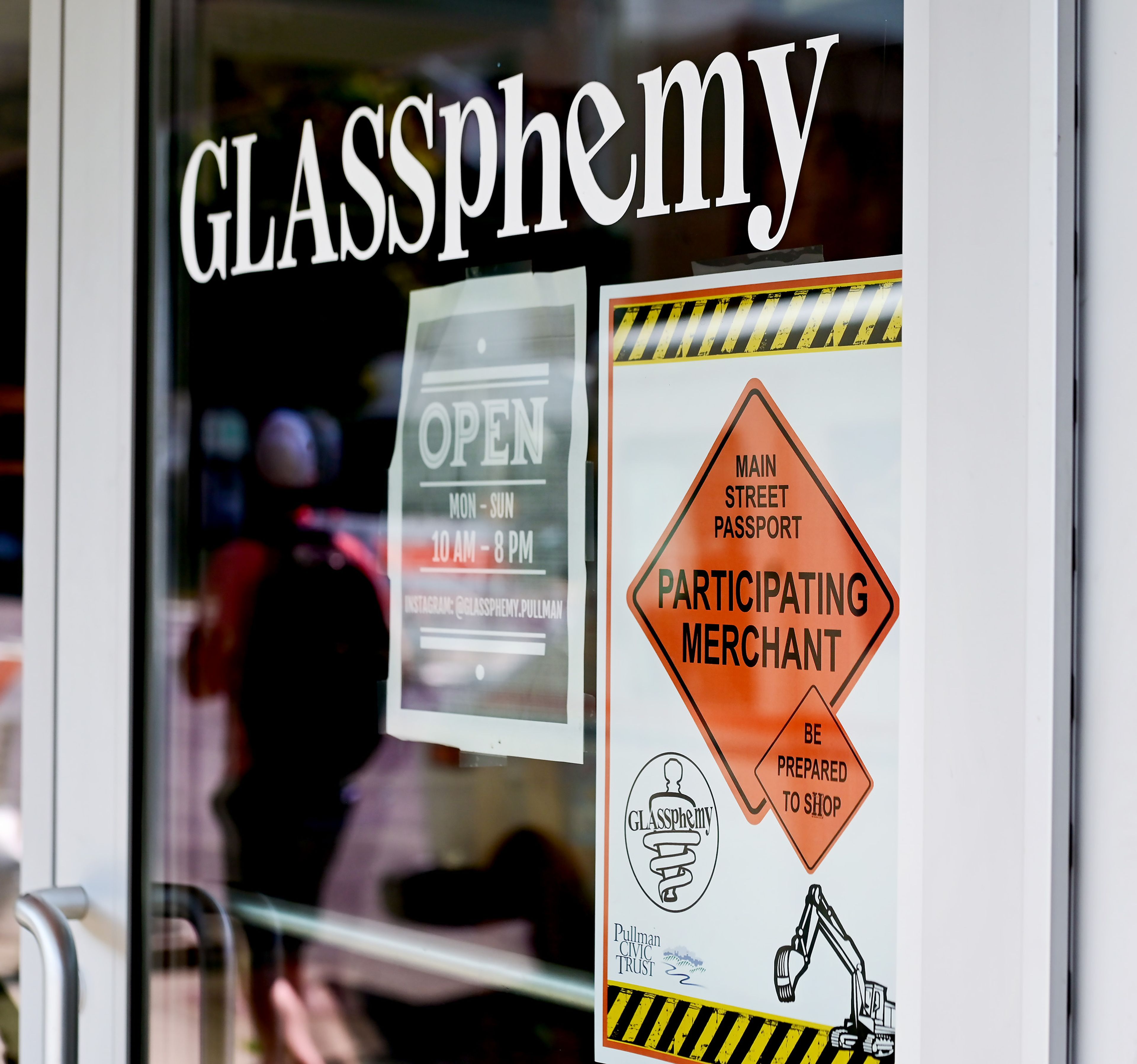 A Main Street Passport sign hangs in the window of Glassphemy on Wednesday in Pullman, one of the many efforts to drum up support for downtown businesses in Pullman during construction.