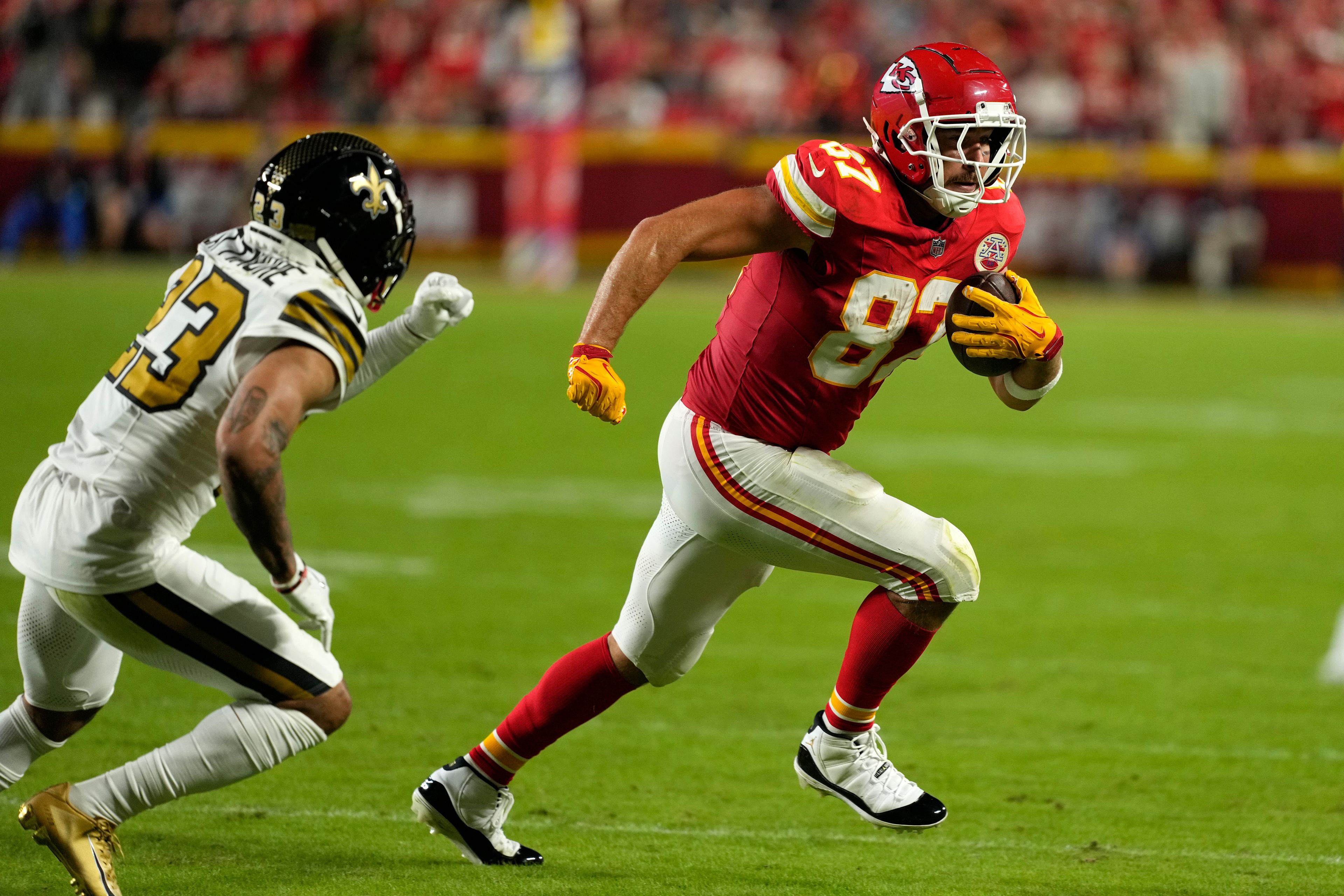 Kansas City Chiefs tight end Travis Kelce (87) runs pas New Orleans Saints cornerback Marshon Lattimore (23) during the first half of an NFL football game Monday, Oct. 7, 2024, in Kansas City, Mo. (AP Photo/Charlie Riedel)